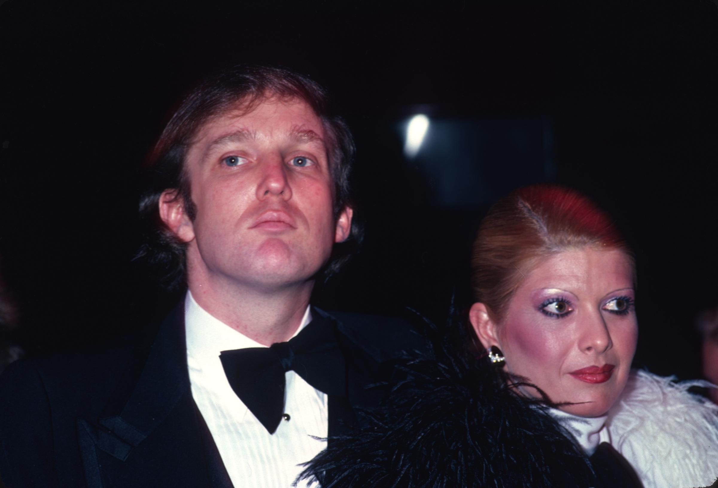 Donald Trump sports a full head of dark brown hair while attending Roy Cohn's birthday party with his then-wife Ivana Trump in New York City in February 1980.
