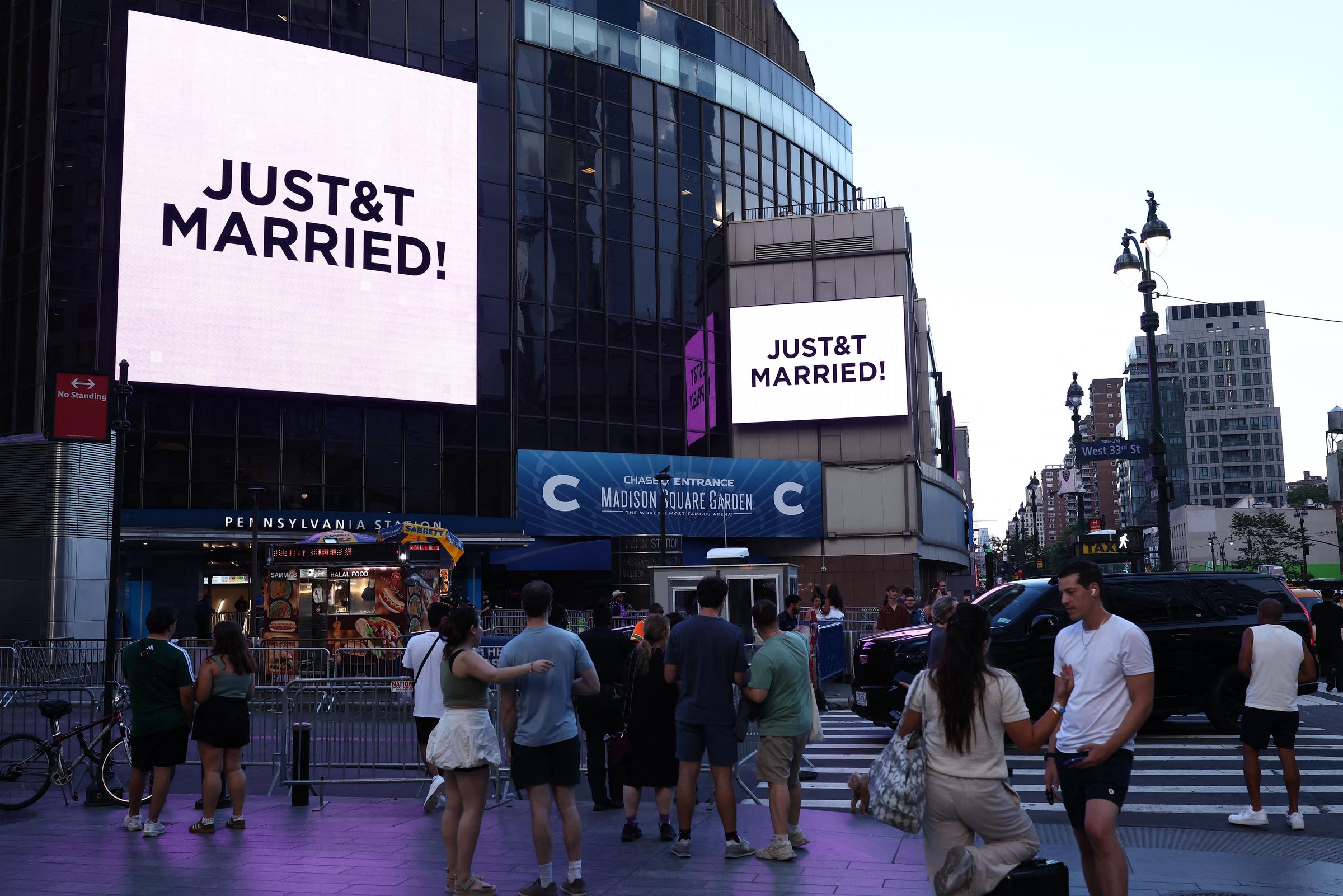 Fans outside got only this sign as confirmation of the upcoming nuptials. In this photo, they watched giant screens showing the message "JUST&T MARRIED!" outside Madison Square Garden in New York City, New York, on July 3, 2026. | Source: Getty Images