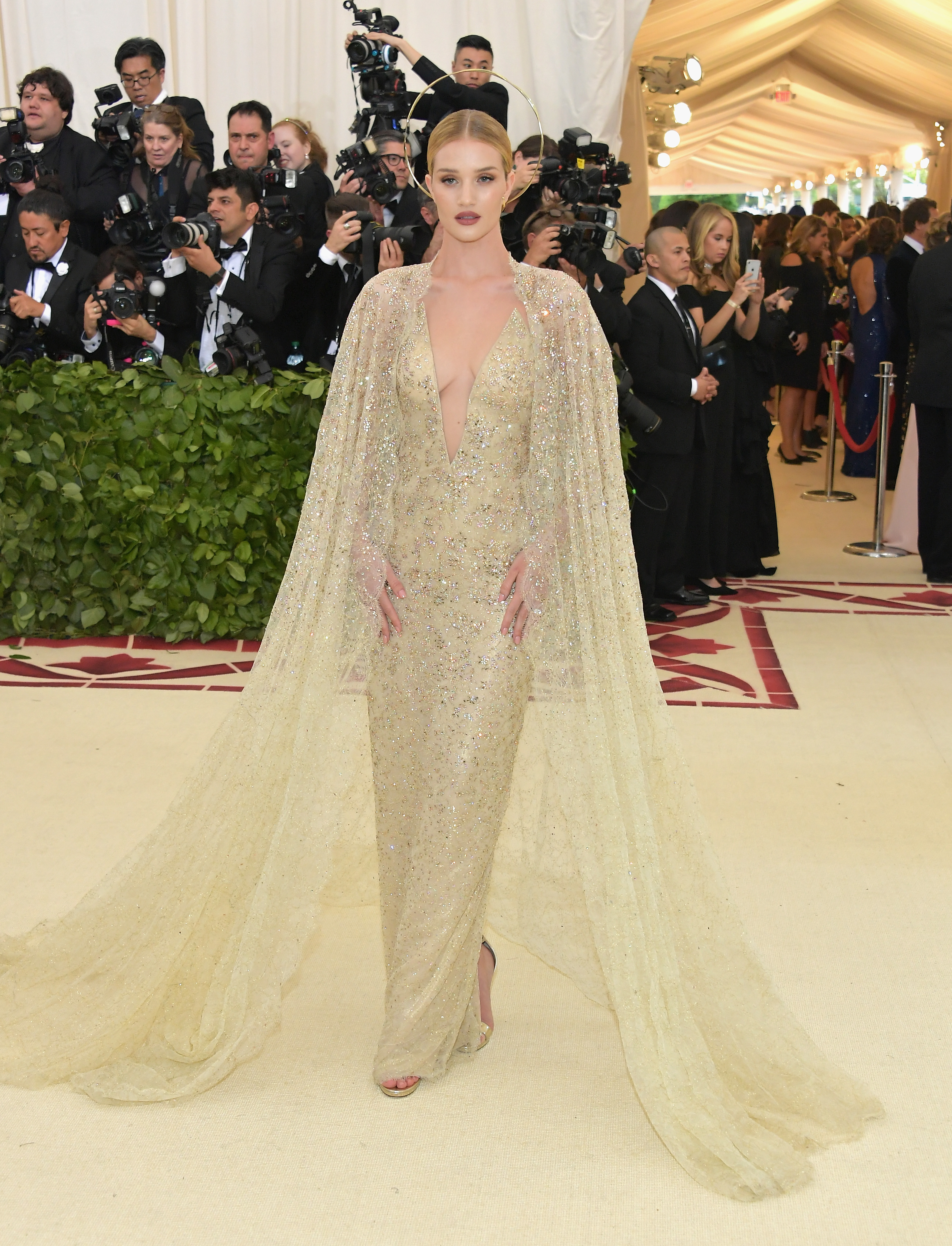 Rosie Huntington-Whiteley channels modern-day divinity in a vision in shimmering gold with an ethereal halo to match at  Heavenly Bodies: Fashion & The Catholic Imagination Costume Institute Gala. | Source: Getty Images