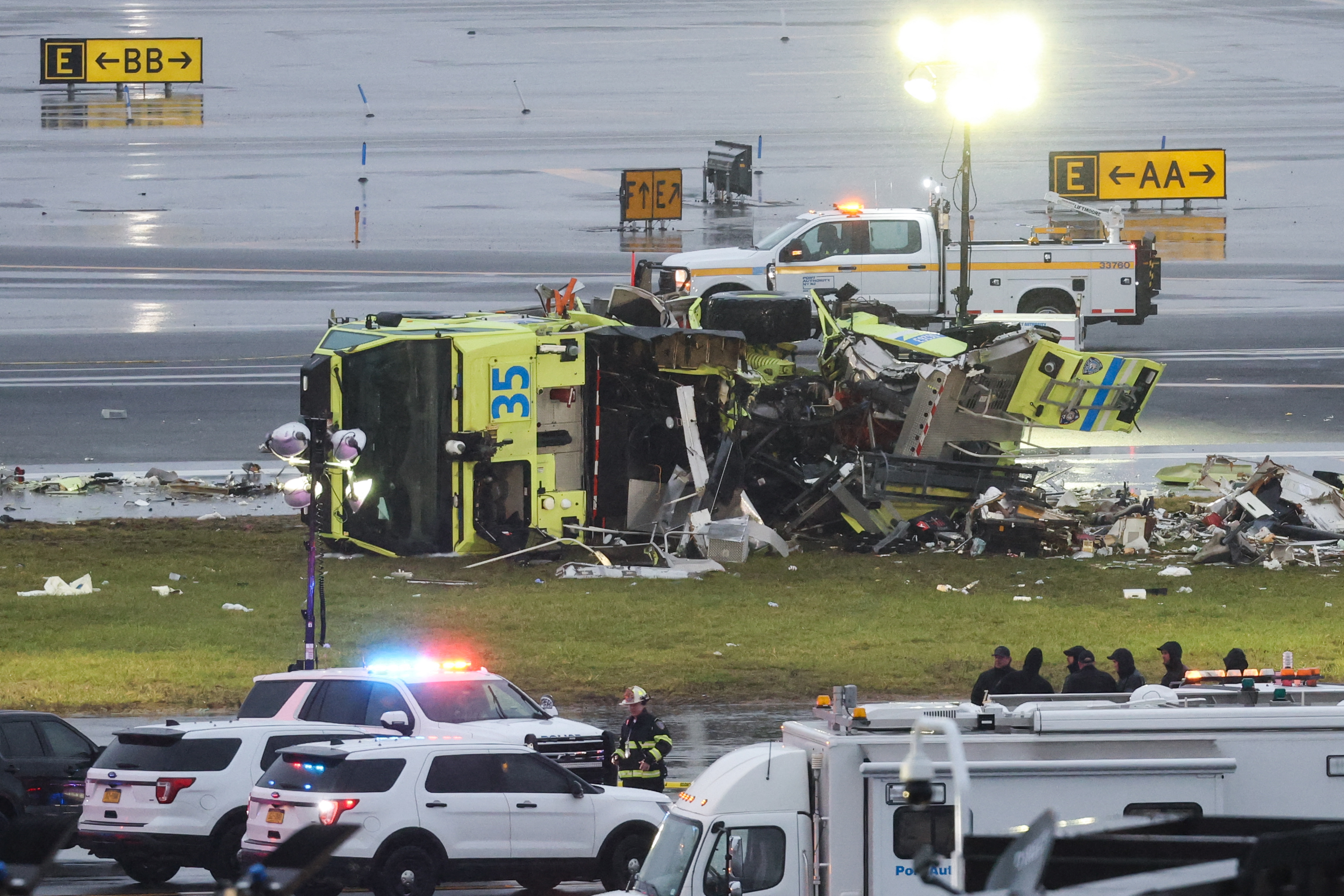 A damaged Port Authority fire truck sits near the runway after colliding with an Air Canada Express CRJ-900 at LaGuardia Airport on March 23, 2026, in New York City | Getty Images