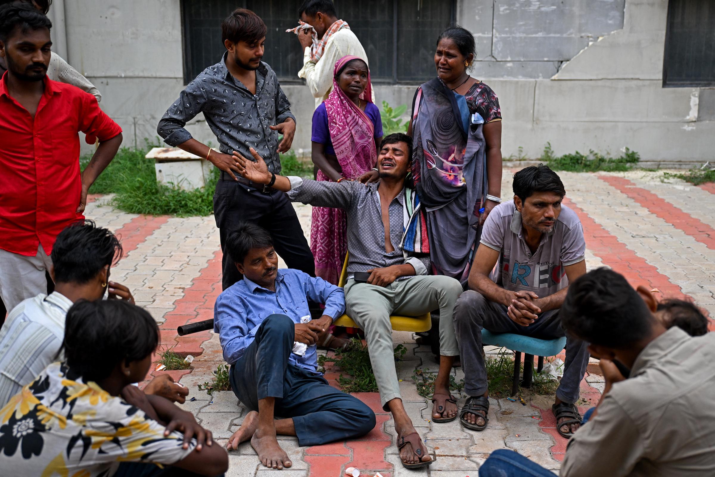 Kalpesh Patni along with family members, mourns the death of his brother Akash Patni, nearby when Air India flight 171 crashed in a residential area, at the hospital mortuary in Ahmedabad on June 13, 2025 | Source: Getty Images