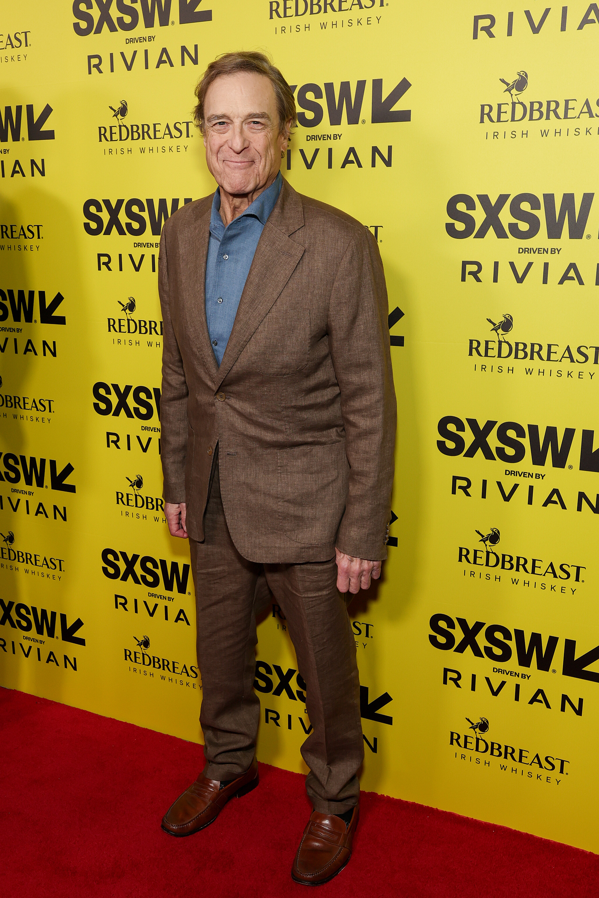 John Goodman arrives at the premiere of Chili Finger during the 2026 SXSW Conference and Festival at ZACH Theatre on March 14, 2026, in Austin, Texas, as the actor’s appearance brought renewed attention to the transformation he has undergone since his Roseanne years. | Source: Getty Images