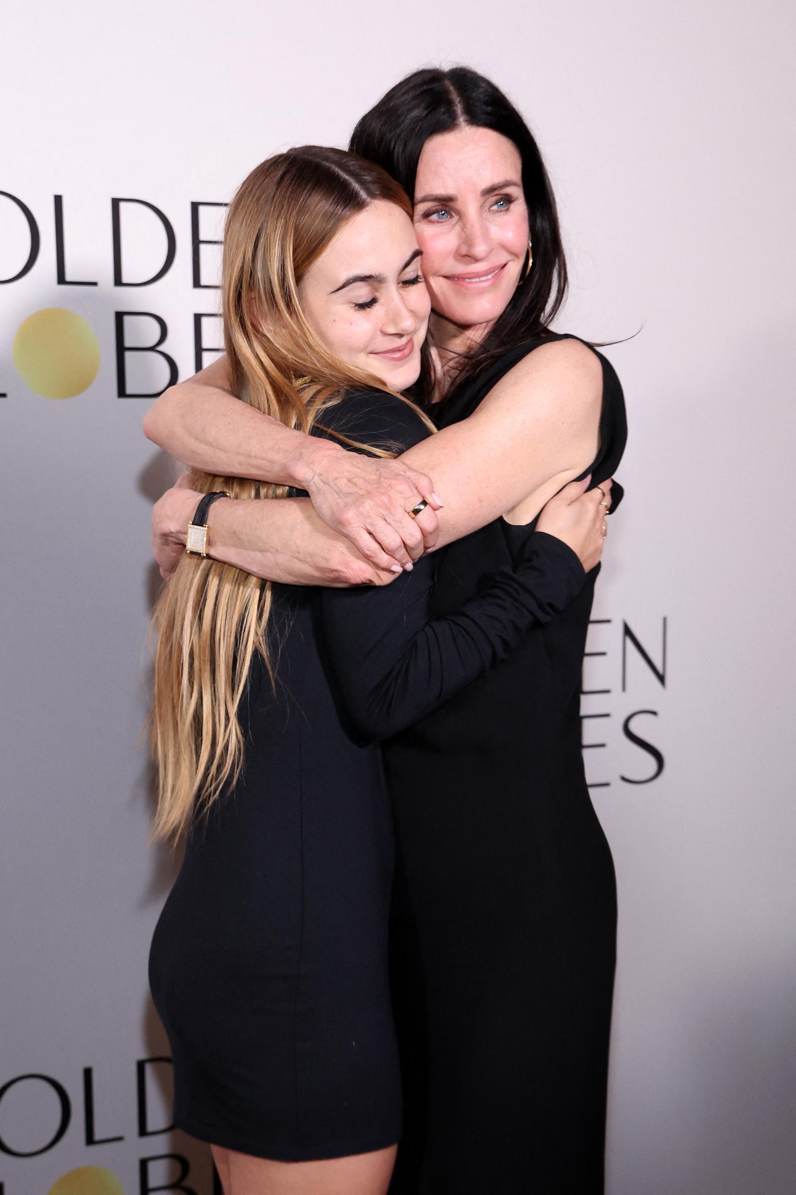 Courtney holds Coco close as they pose for the cameras, with Coco leaning into her mother and closing her eyes in the embrace. Their matching black ensembles keep the portrait understated, while the affectionate pose offers a more intimate glimpse of their TIFF appearance. | Source: Getty Images