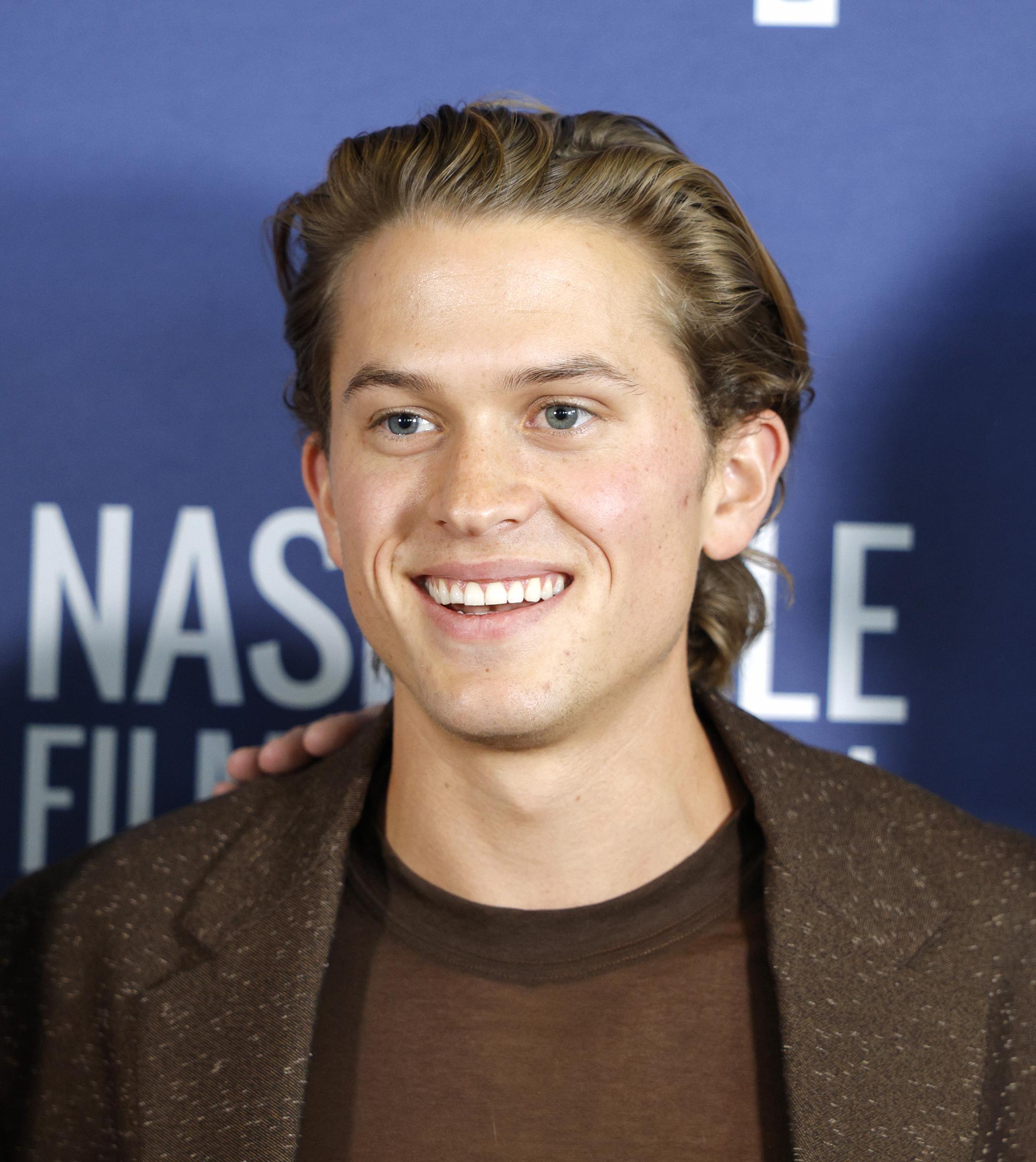 All eyes were on Deacon as he arrived for the world premiere of "Brother Save Us." A close-up put the focus on his swept-back hair and understated styling as he marked his first feature-film role.