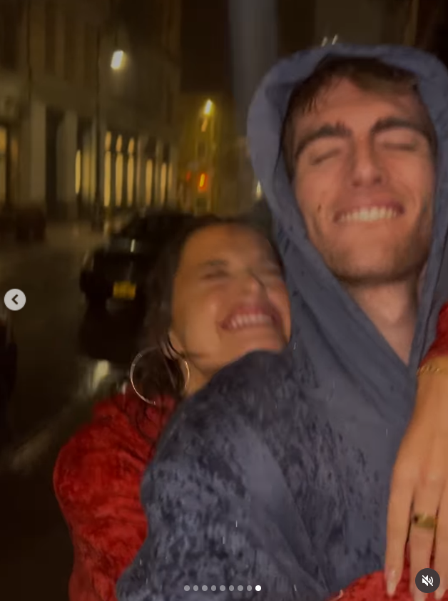 Wood and Gerber smile together while walking outside in the rain in a video included in the post. The moving clip rounded out a collection that mixed candid and affectionate moments from their time together. | Source: Instagram/lexiwood