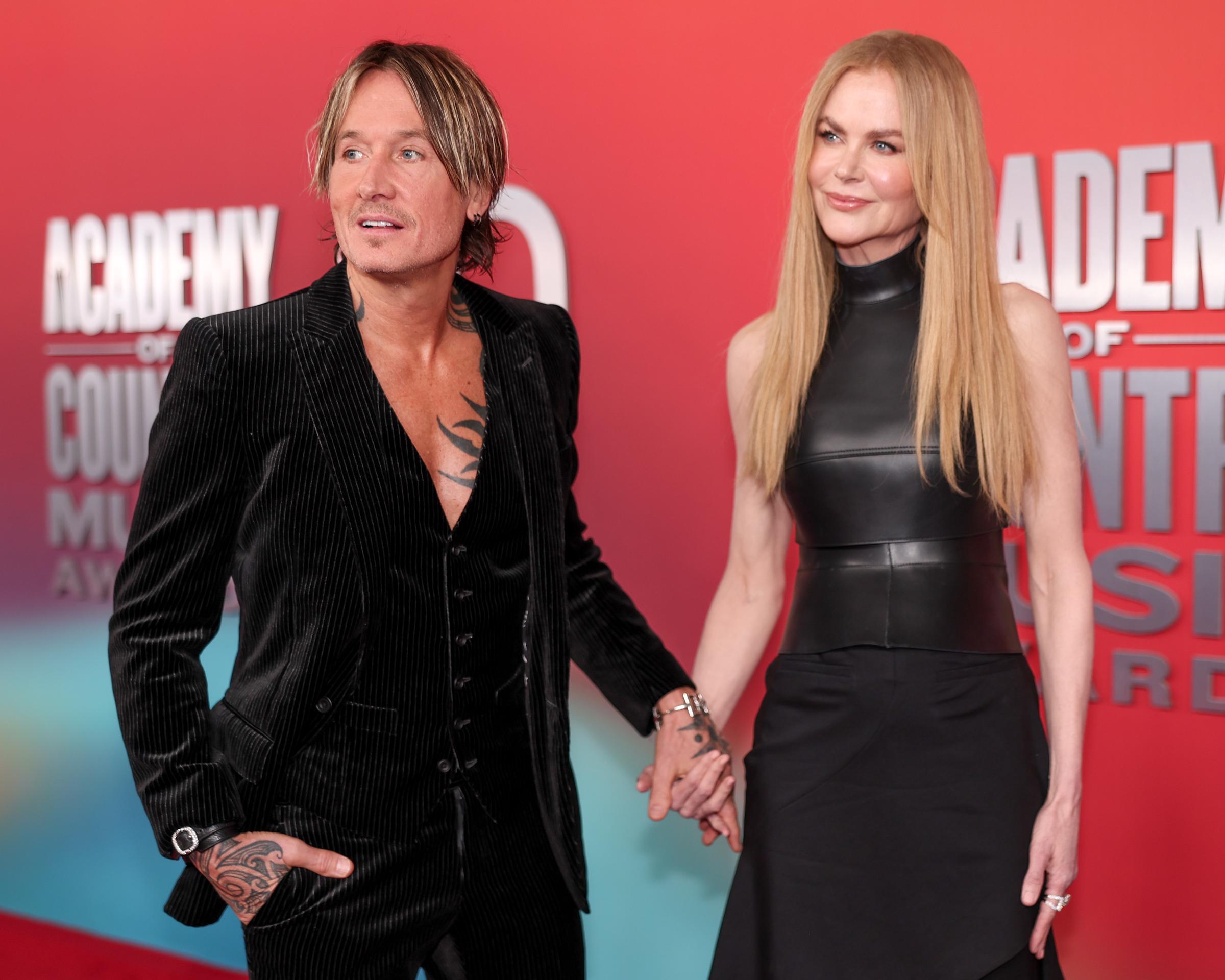 Keith Urban and Nicole Kidman hold hands on the red carpet at the 2025 ACM Awards | Source: Getty Images