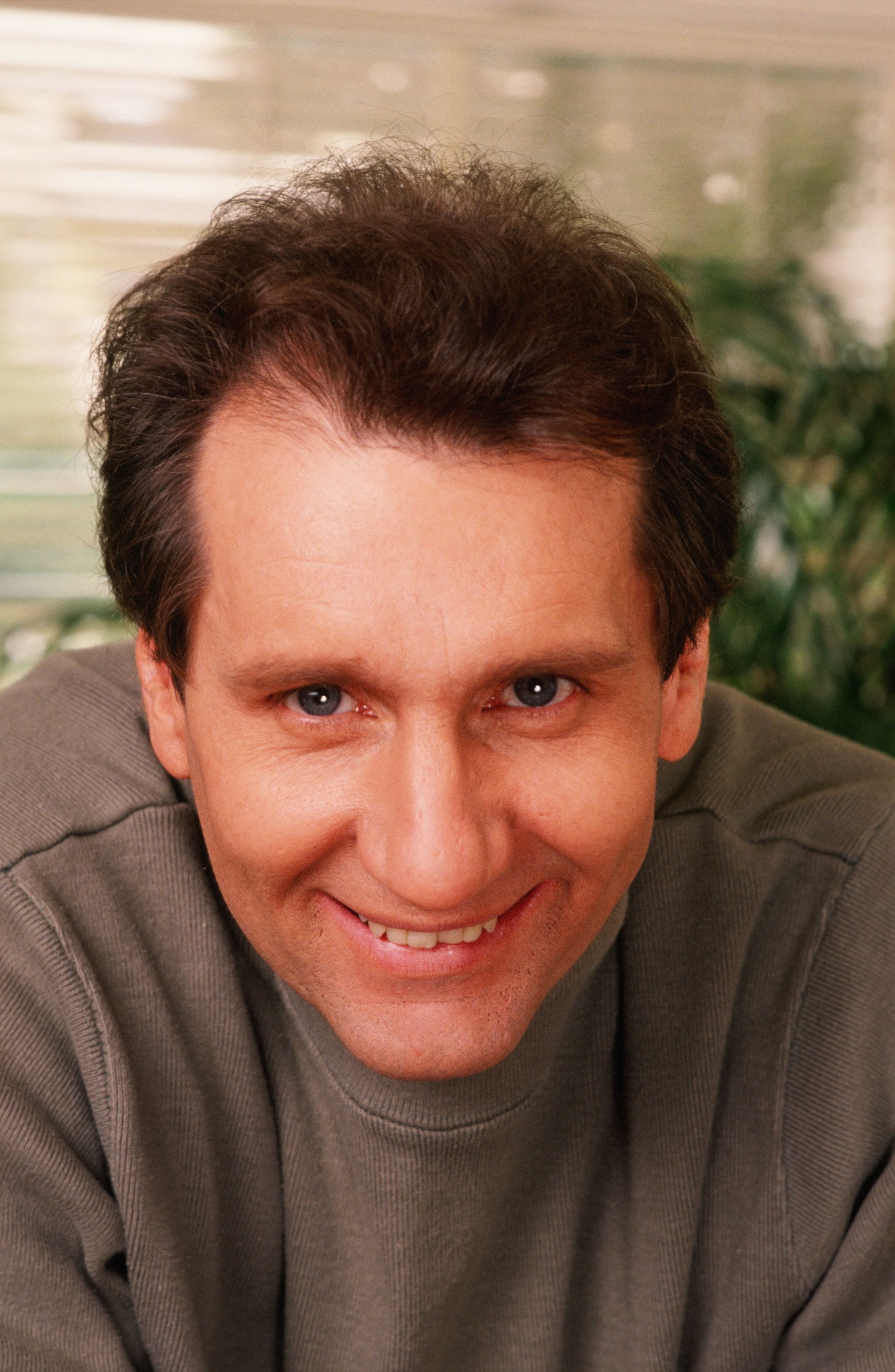 Ed O'Neill leaned forward with a wry, knowing smile during an intimate portrait session in 1989 in Los Angeles, California. Dressed down in a simple olive-grey sweatshirt, the acclaimed actor took a break from playing his famously cynical alter ego, Al Bundy, on the smash-hit sitcom "Married... with Children". | Source: Getty Images