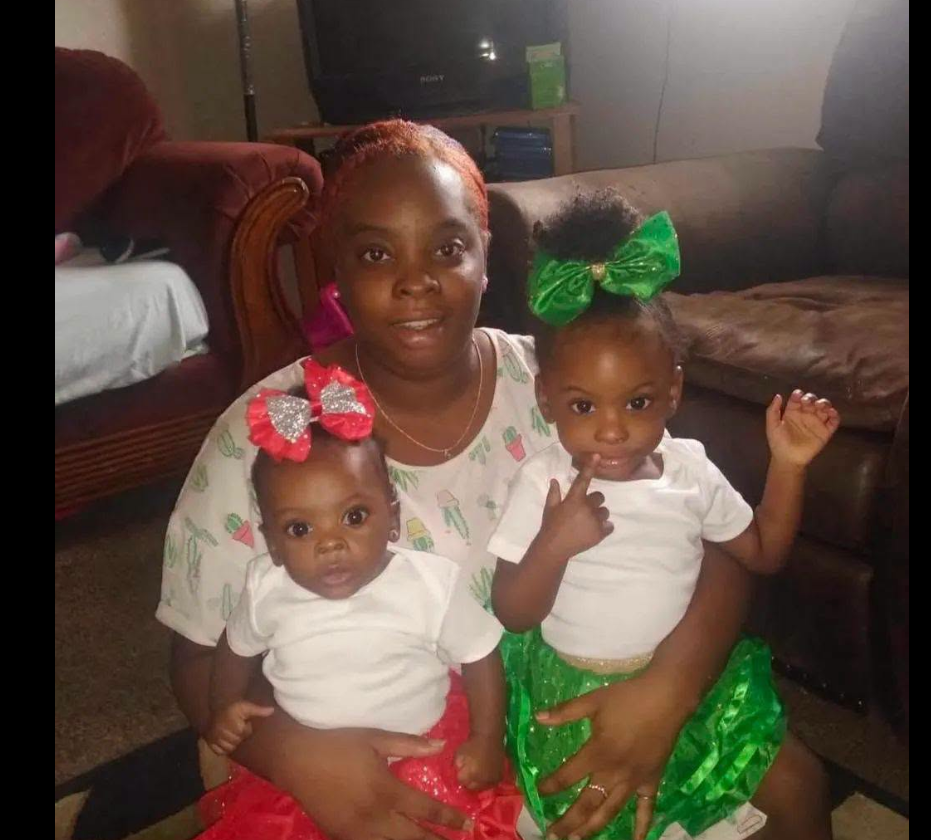 A warm photo of Shaneiqua Elkins shows her seated with two of her children on her lap, each dressed in coordinated outfits with bright bows. | Source: Facebook/Crime Pulse Daily