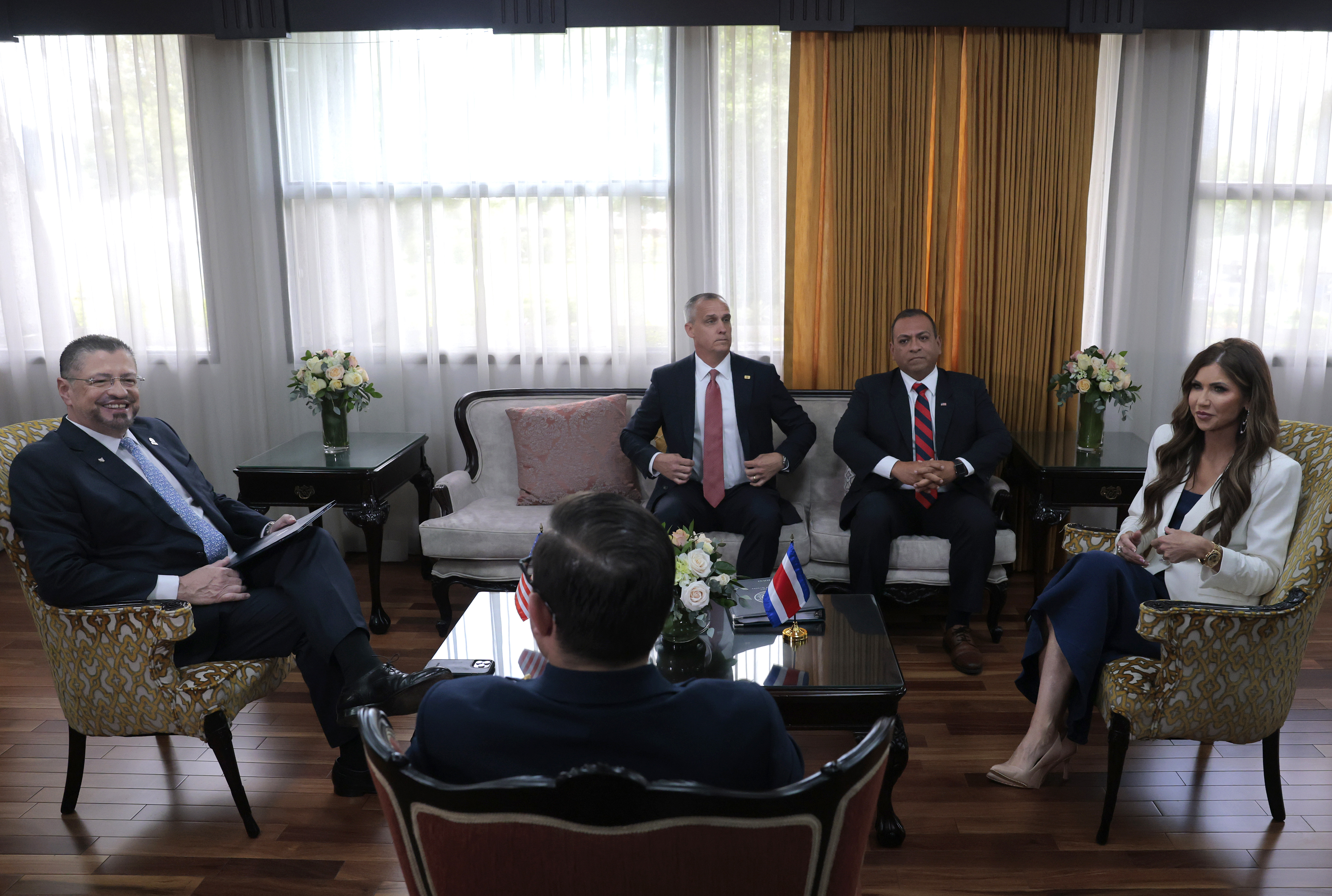 Corey Lewandowski and Mike Flores appear in a room with former Homeland Security Secretary Kristi Noem during a meeting with the President of Costa Rica, Rodrigo Chaves Robles, in San Jose, Costa Rica on June 25, 2025. | Source: Getty Images