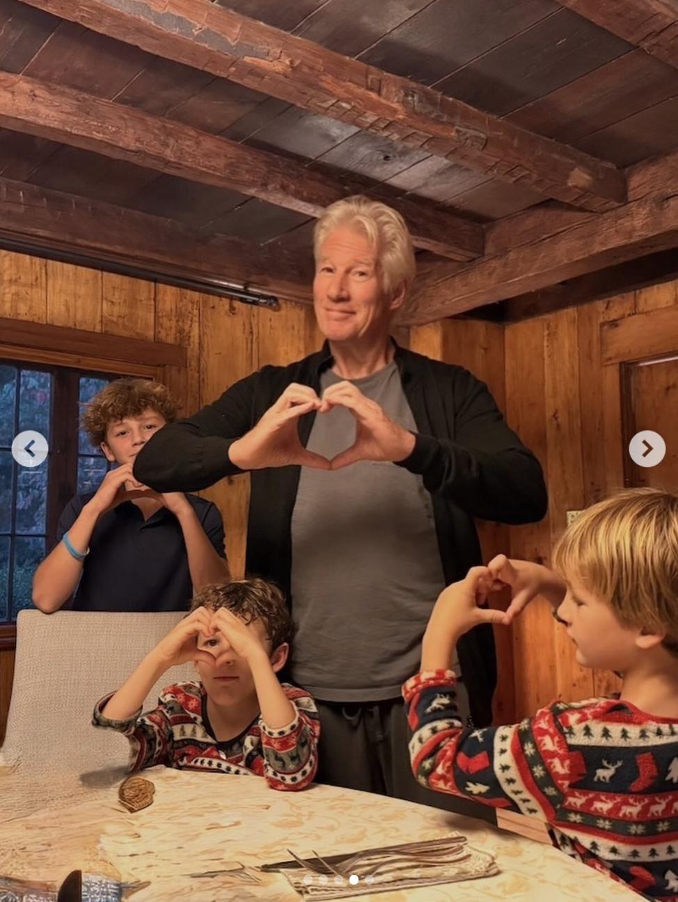 Richard Gere and his children gather around a dining table inside the family's Spain home, where exposed wooden beams and paneled walls create a warm, rustic atmosphere. | Source: Instagram/alejandragere