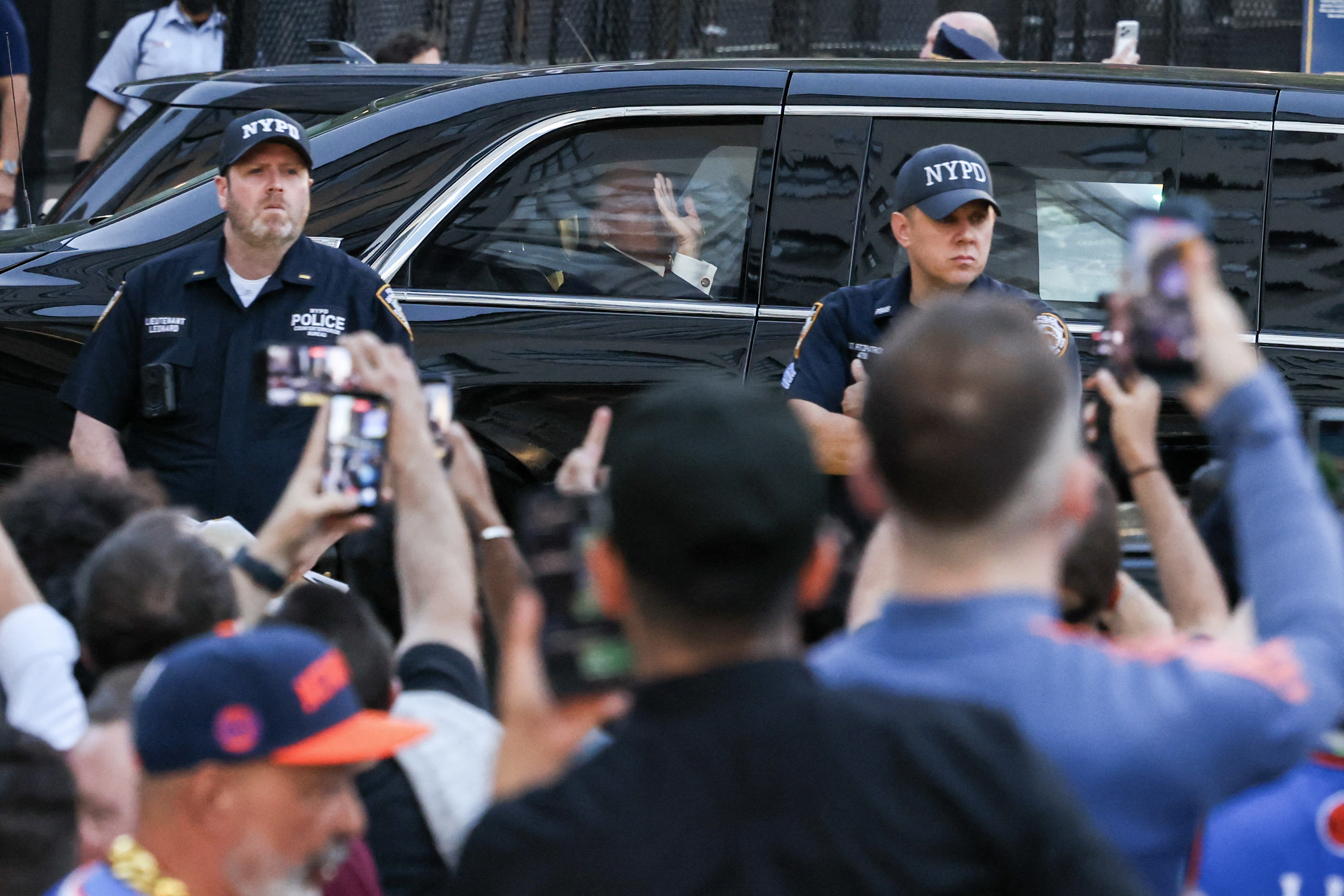 Donald Trump waves from his motorcade as fans gather outside Madison Square Garden ahead of Game 3 of the NBA Finals. His visit brought heightened security measures and drew significant attention around the arena. | Source: Getty Images