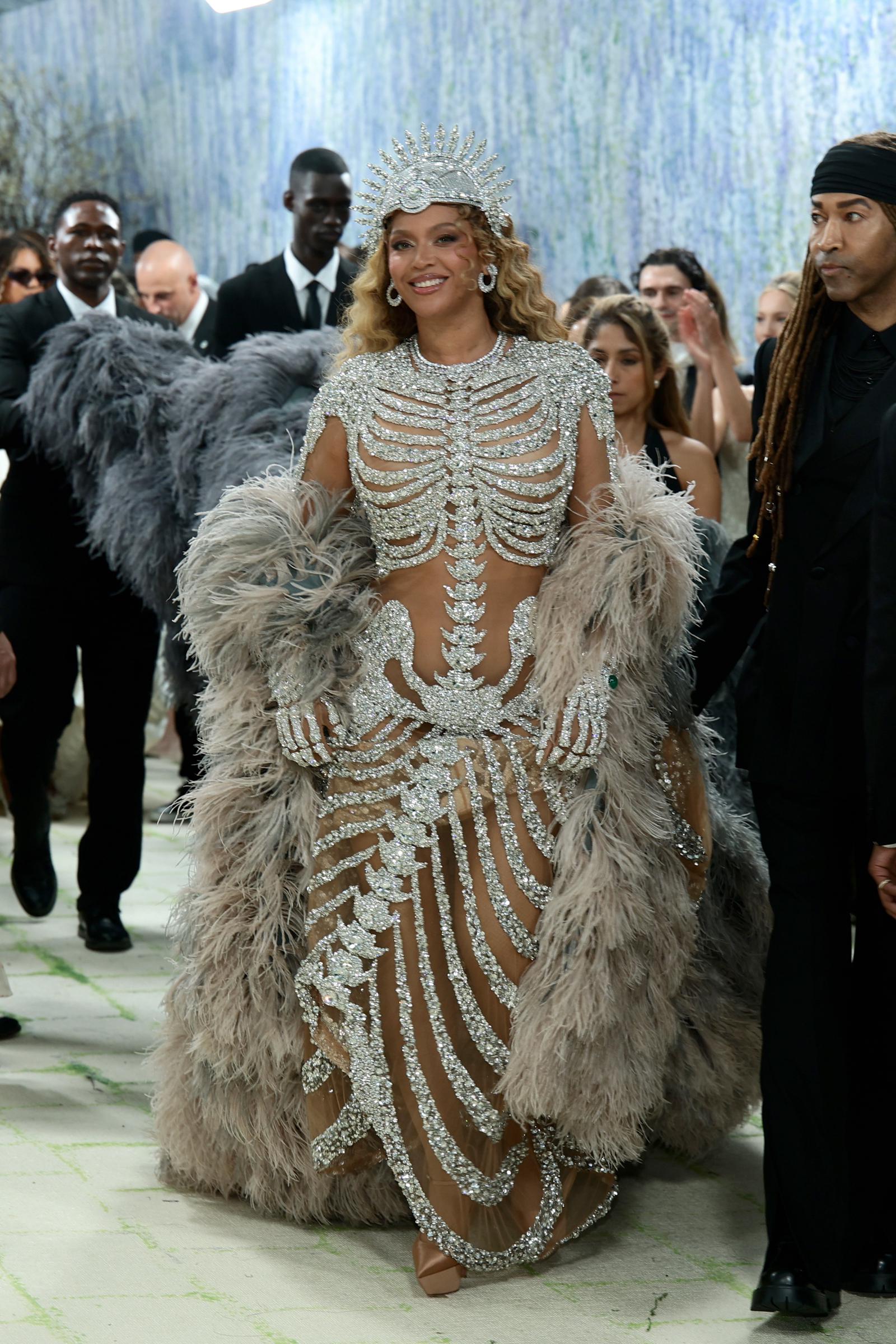 Beyoncé arrives at the 2026 Met Gala in a crystal-embellished gown with a feathered coat | Source: Getty Images