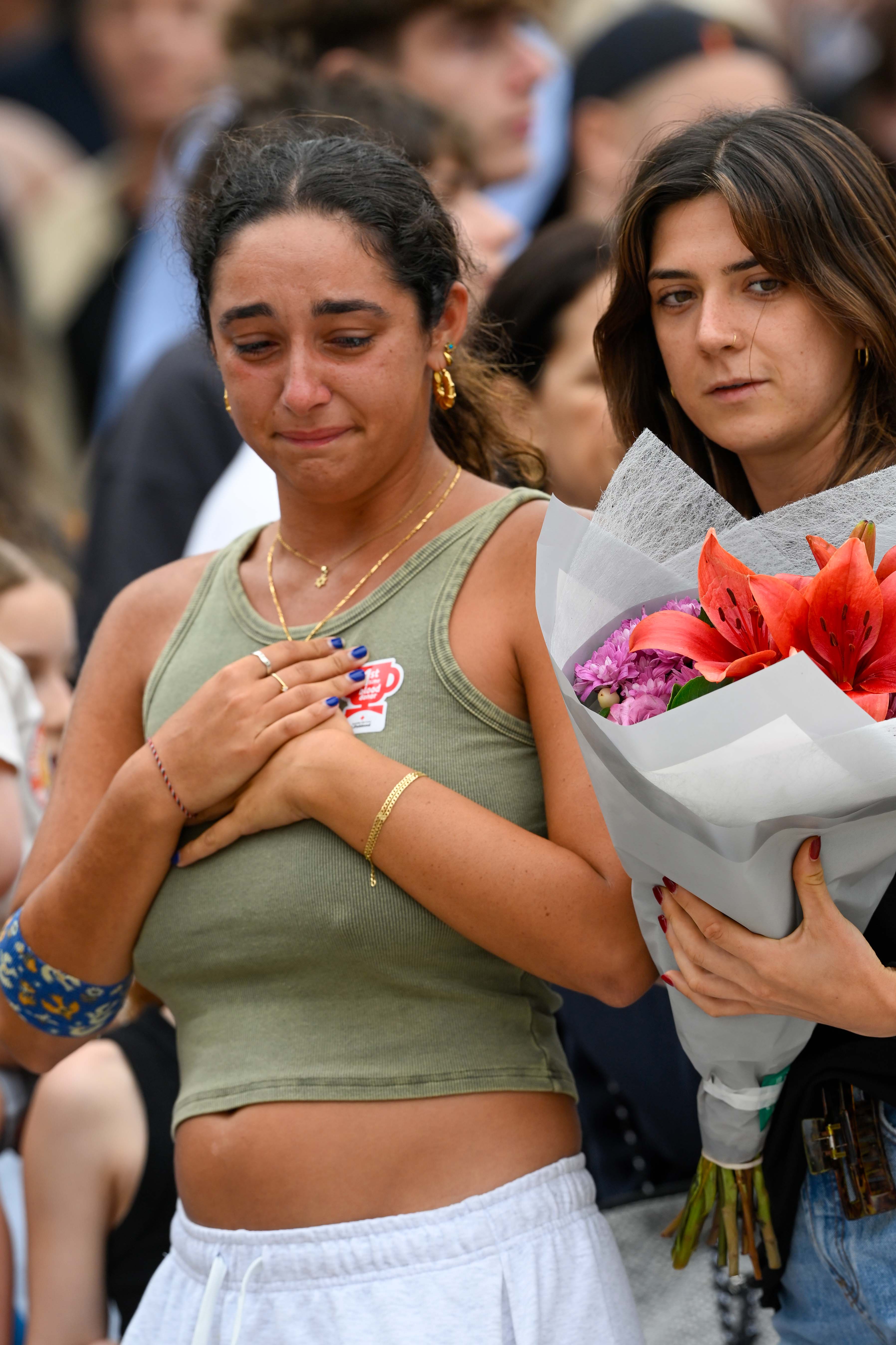 A woman crying as people visit Bondi Pavilion to lay flowers in tribute to the victims of a terrorist attack in Sydney on December 15, 2025. | Source: Getty Images