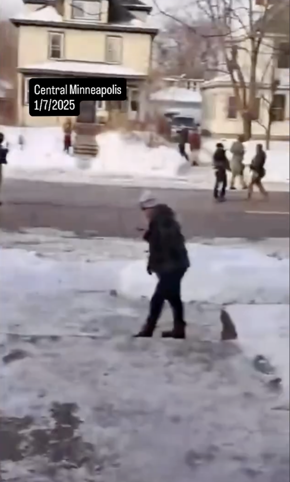 Renee Nicole Good's alleged wife standing near the car crash site after she was shot by an ICE agent on January 7, 2026 | Source: Instagram/migrantinsider