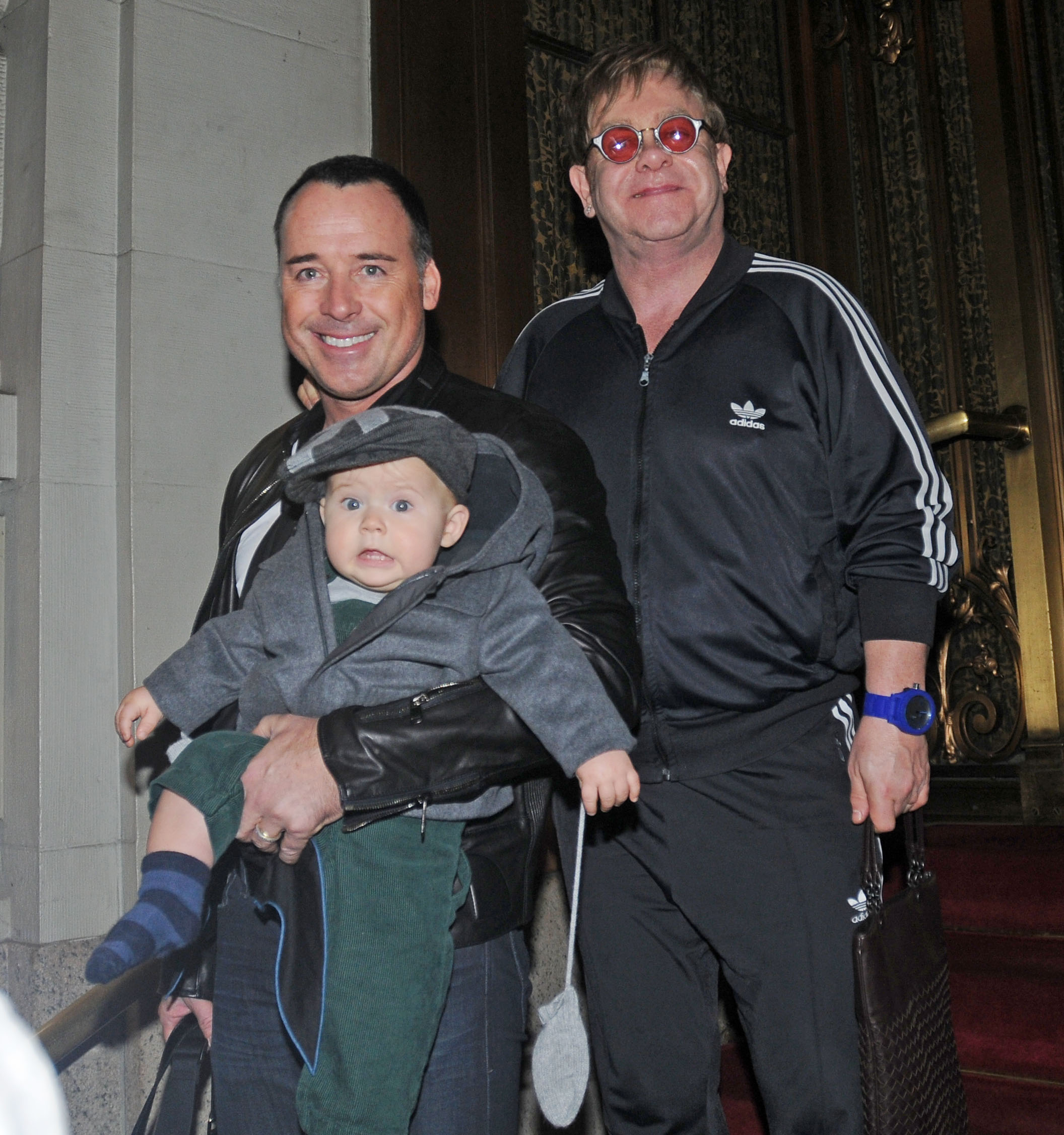 David Furnish and Elton John with their son, Zachary Furnish-John, leaving their hotel on October 27, 2011, in New York. | Source: Getty Images