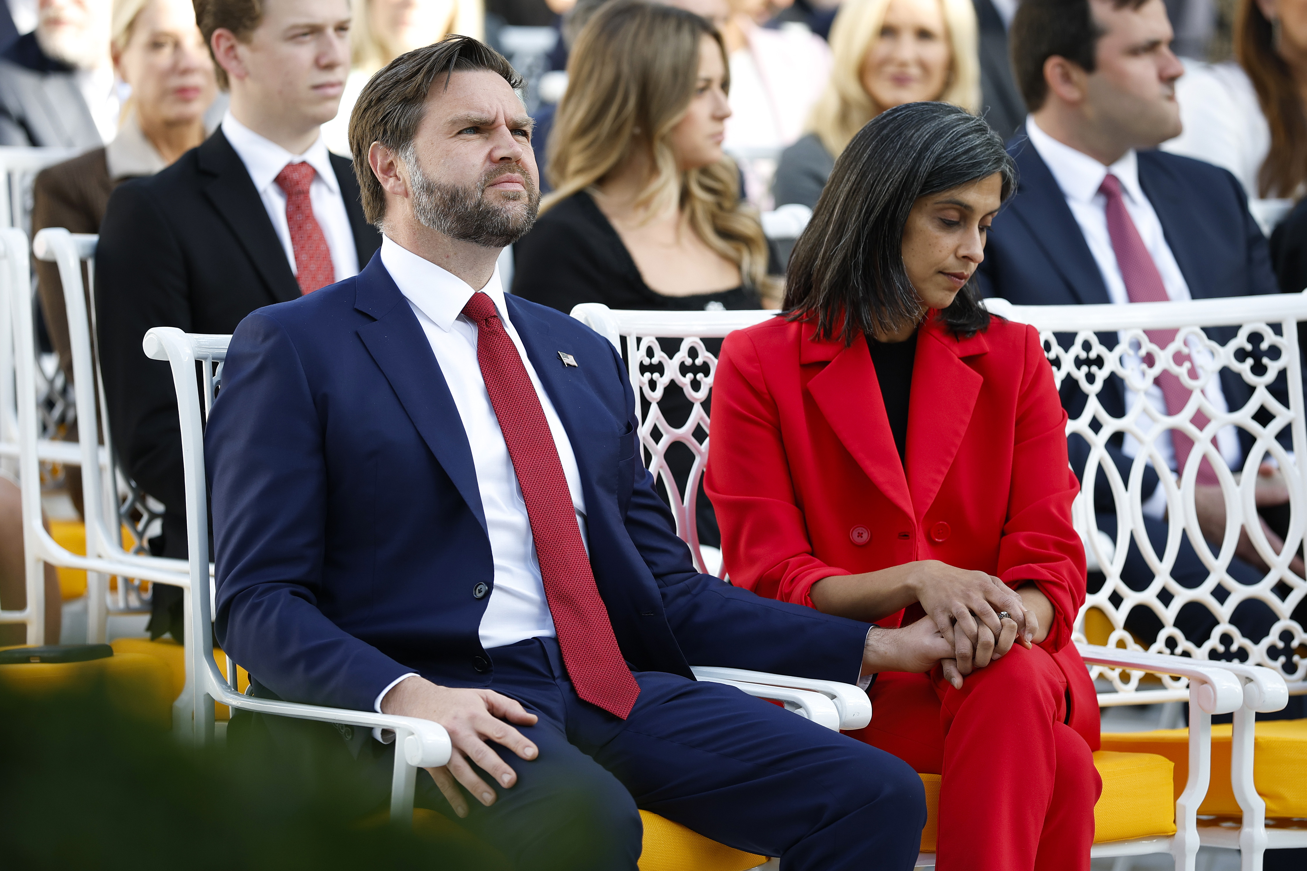 Second Lady, Usha Vance sits with her husband Vice President JD Vance, holding hands at a Presidential Medal of Freedom ceremony in the White House Rose Garden on October 14, 2025. | Source: Getty Images