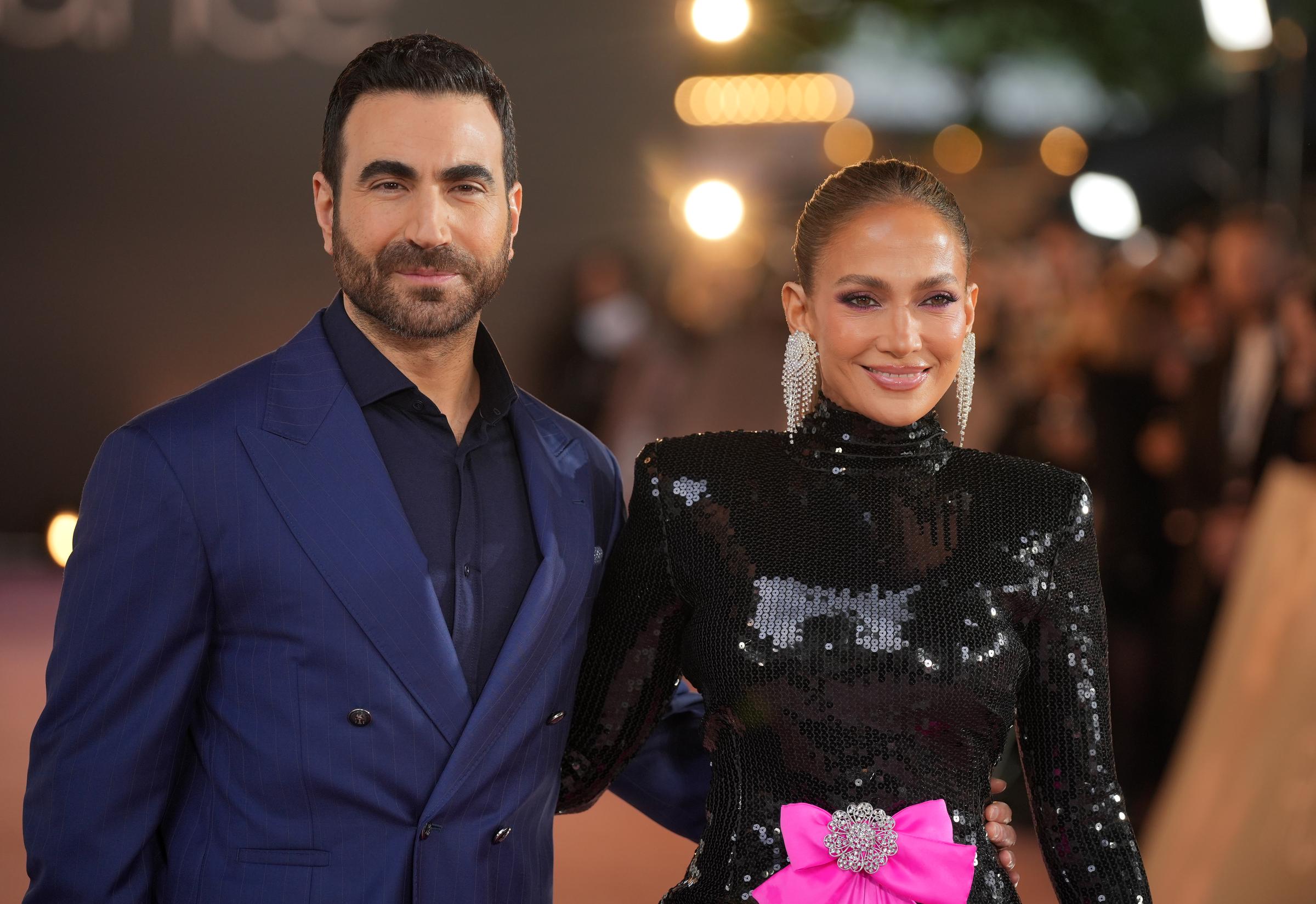 Jennifer Lopez and Brett Goldstein pose together at the UK premiere of "Office Romance" in London on June 3, 2026. Their appearance together offers a closer look at the actor some social media users have compared to Ben Affleck. | Source: Getty Images