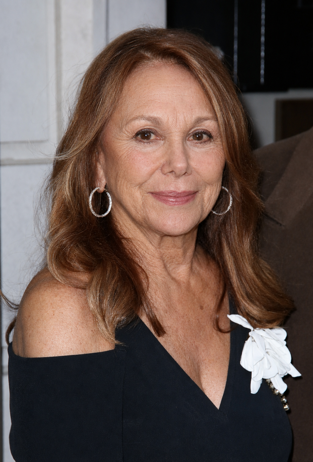 Marlo Thomas poses for an AI-generated portrait in a black off-the-shoulder ensemble accented with a white floral detail. | Source: ChatGPT