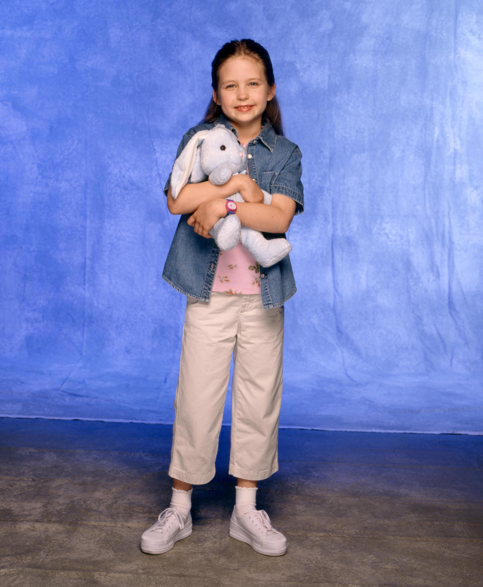 Daveigh Chase poses with a stuffed rabbit while portraying Anna in the television movie "From Where I Sit," one of several projects she appeared in before stepping away from acting after 2016. | Source: Getty Images