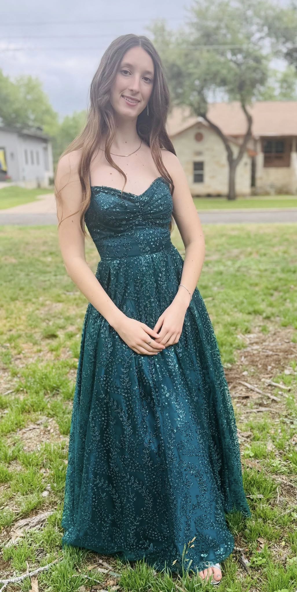Malaya Grace Hammond in a long dress standing in a grassy field. From a posted dated April 5, 2025. | Source: Facebook/elizabeth.m.hammond
