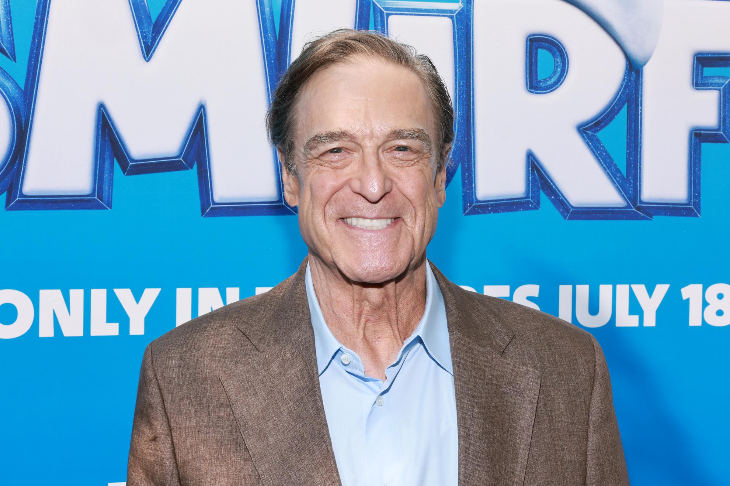 John Goodman smiles at the New York screening of "Smurfs" on July 15, 2025, displaying the dramatically leaner physique he maintained into his 70s. | Source: Getty Images