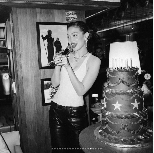 Gigi Hadid celebrates her 30th birthday alongside a lavish tiered cake during the party where she later shared a rare glimpse of her romance with Bradley Cooper, giving fans another look at the celebration that marked their relationship’s Instagram debut. | Source: Instagram/gigihadid