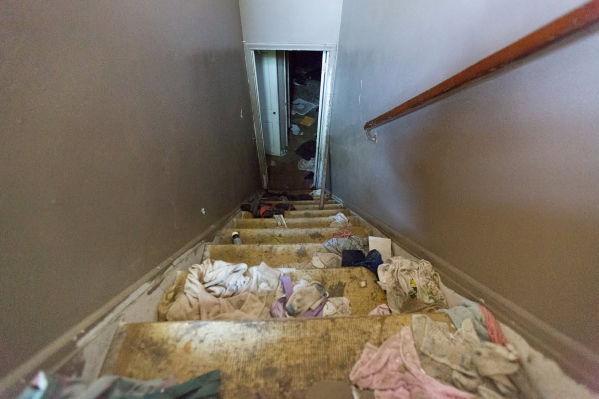 The staircase was littered with discarded clothing and debris by the time the building was documented before demolition. Little remained of the family home that had inspired some of Eminem's best-known lyrics. | Source: Facebook/eminem