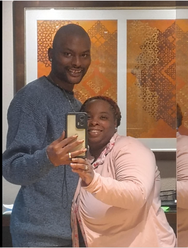 A mirror selfie of Shamar Elkins and Shaneiqua Elkins shows the couple standing close together, smiling warmly as they capture the moment. | Source: Facebook/Shaneiqua Elkins