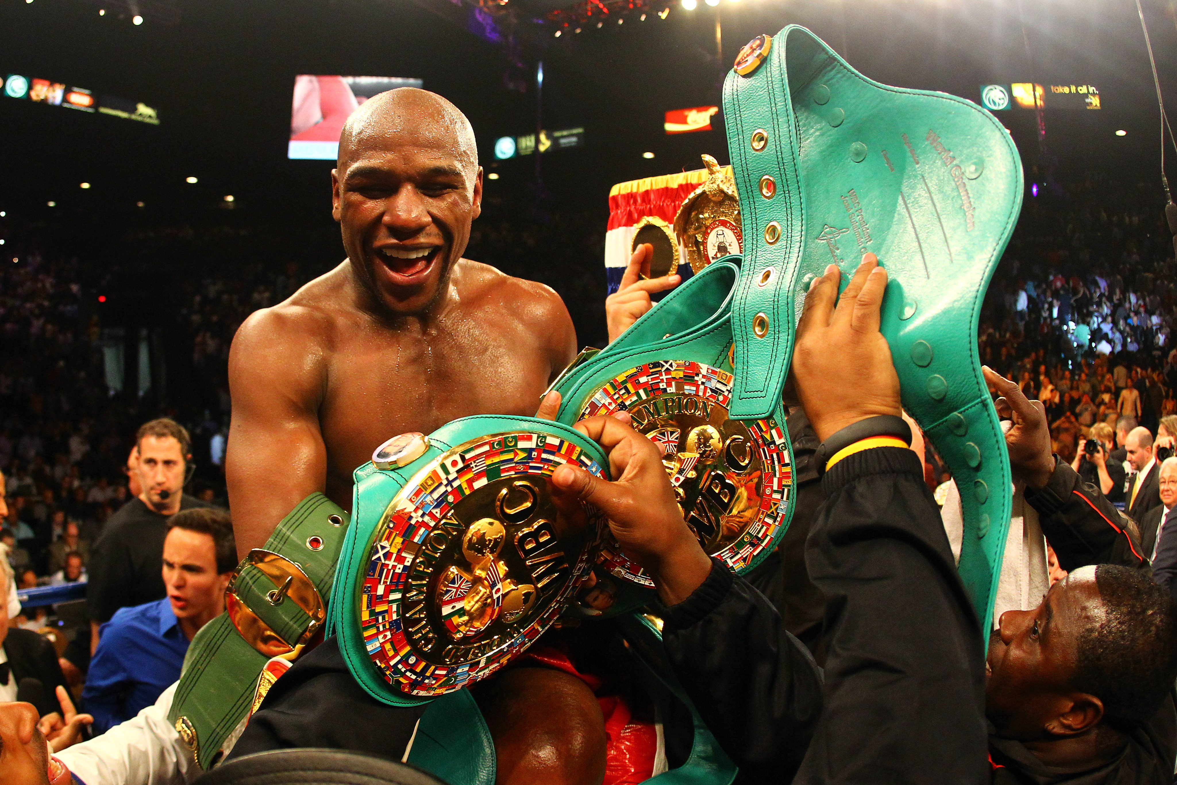 Floyd Mayweather Jr. celebrates after defeating Miguel Cotto by unanimous decision during their WBA super welterweight title fight on May 5, 2012 | Source: Getty Images