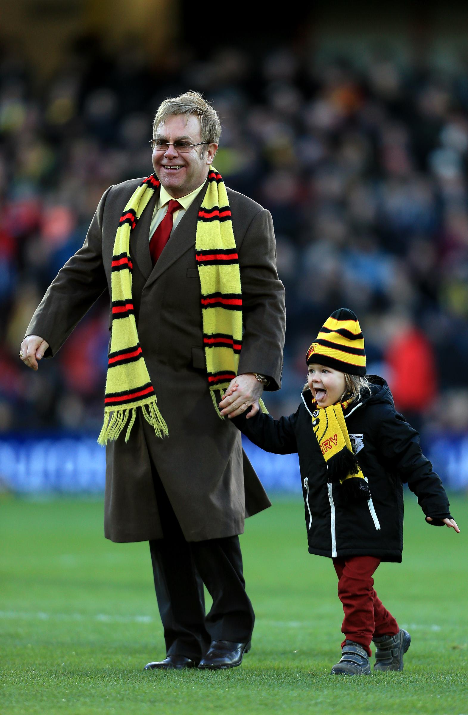 Elton John on a soccer pitch with his son, Zachary Furnish-John, on December 13, 2014. | Source: Getty Images