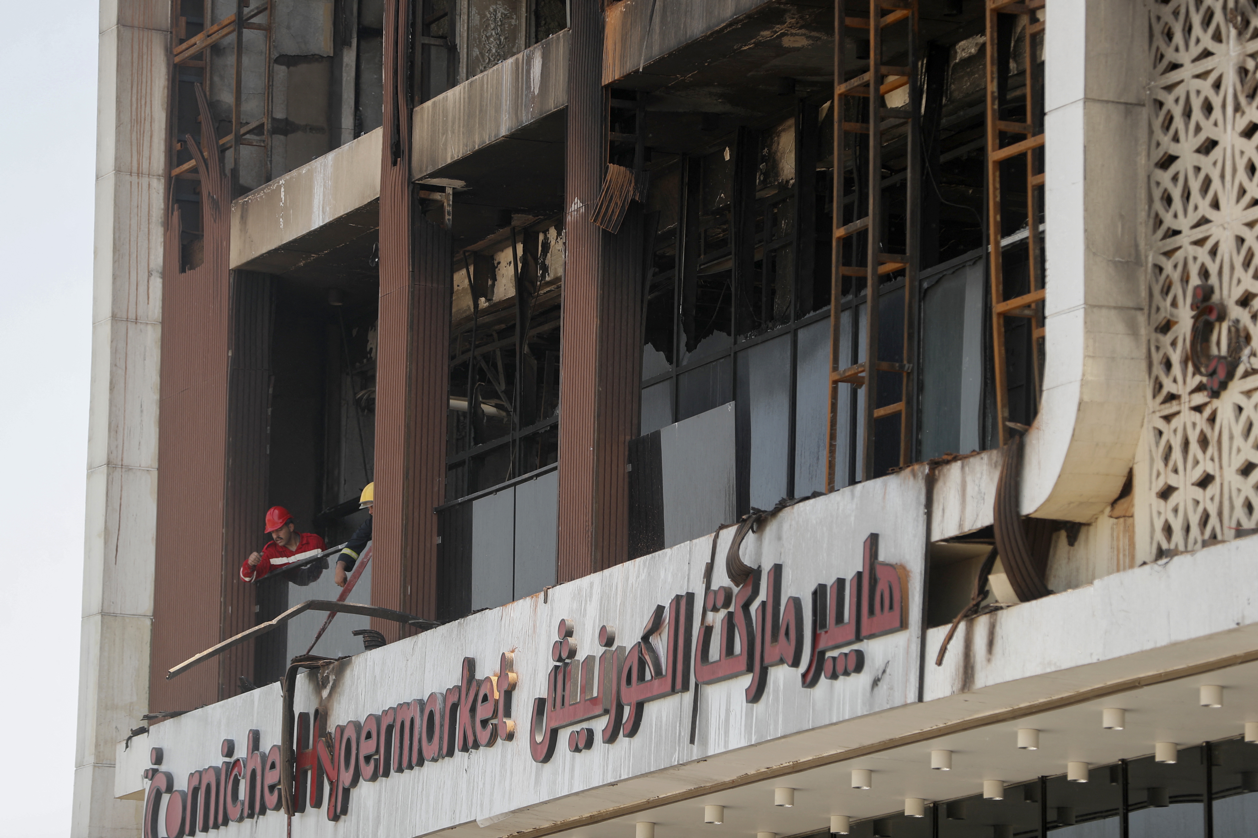 Emergency crew cleans rubble and debris from the damaged Hyper Mall in Kut, Iraq on July 17, 2025. | Source: Getty Images