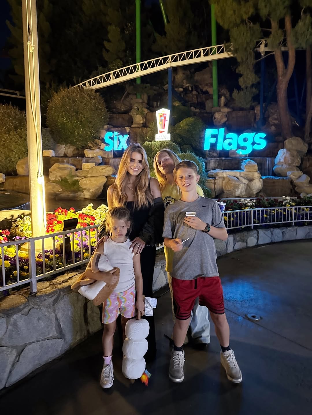Jessica Simpson and her children, Maxwell, Ace, and Birdie Mae Johnson, posing in front of the Six Flags sign, from a post dated July 1, 2025 | Source: Instagram/jessicasimpson