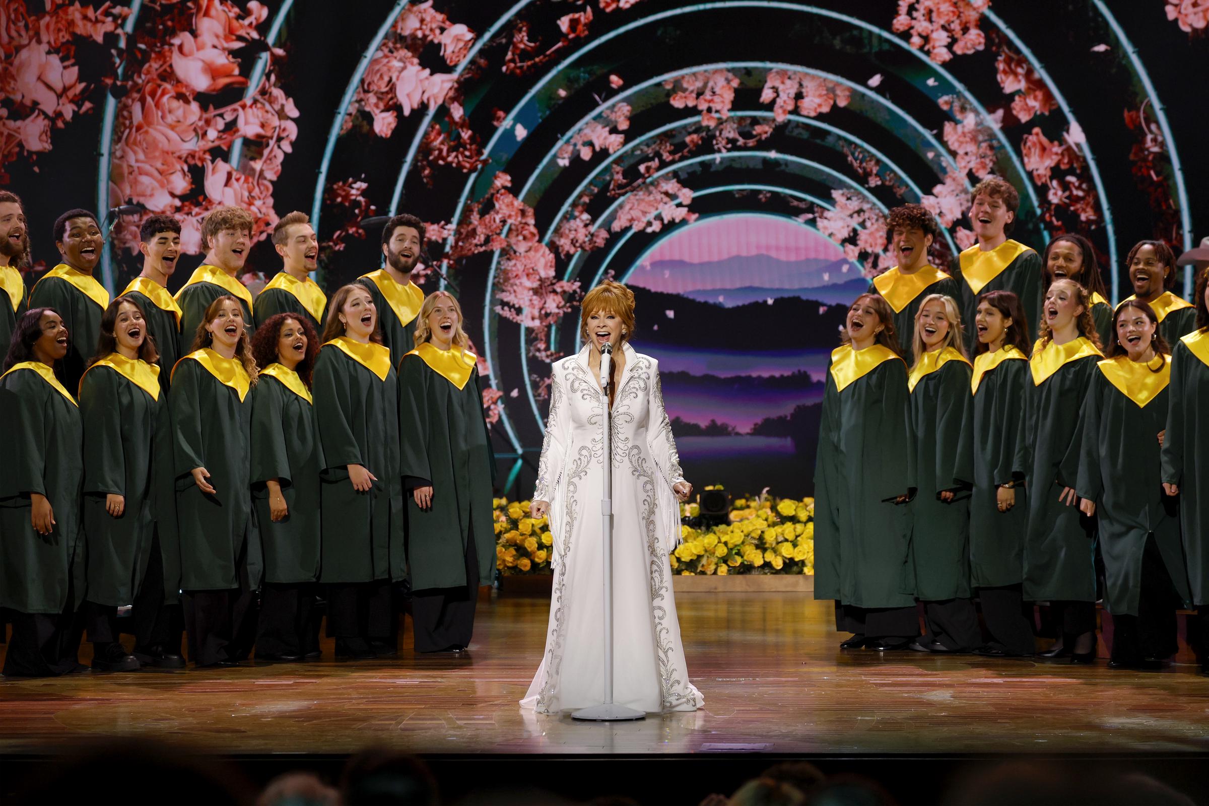 Reba McEntire takes center stage alongside a choir as she performs during the star-studded Dolly Parton celebration in Nashville on October 21, 2026. | Source: Getty Images