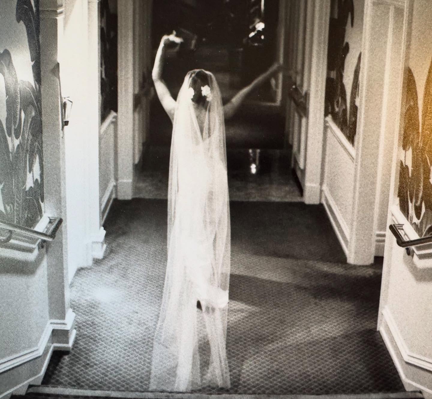 Lisa Rinna celebrates with her arms raised, showing off her dramatic floor-length bridal veil. | Source: Instagram/lisarinna