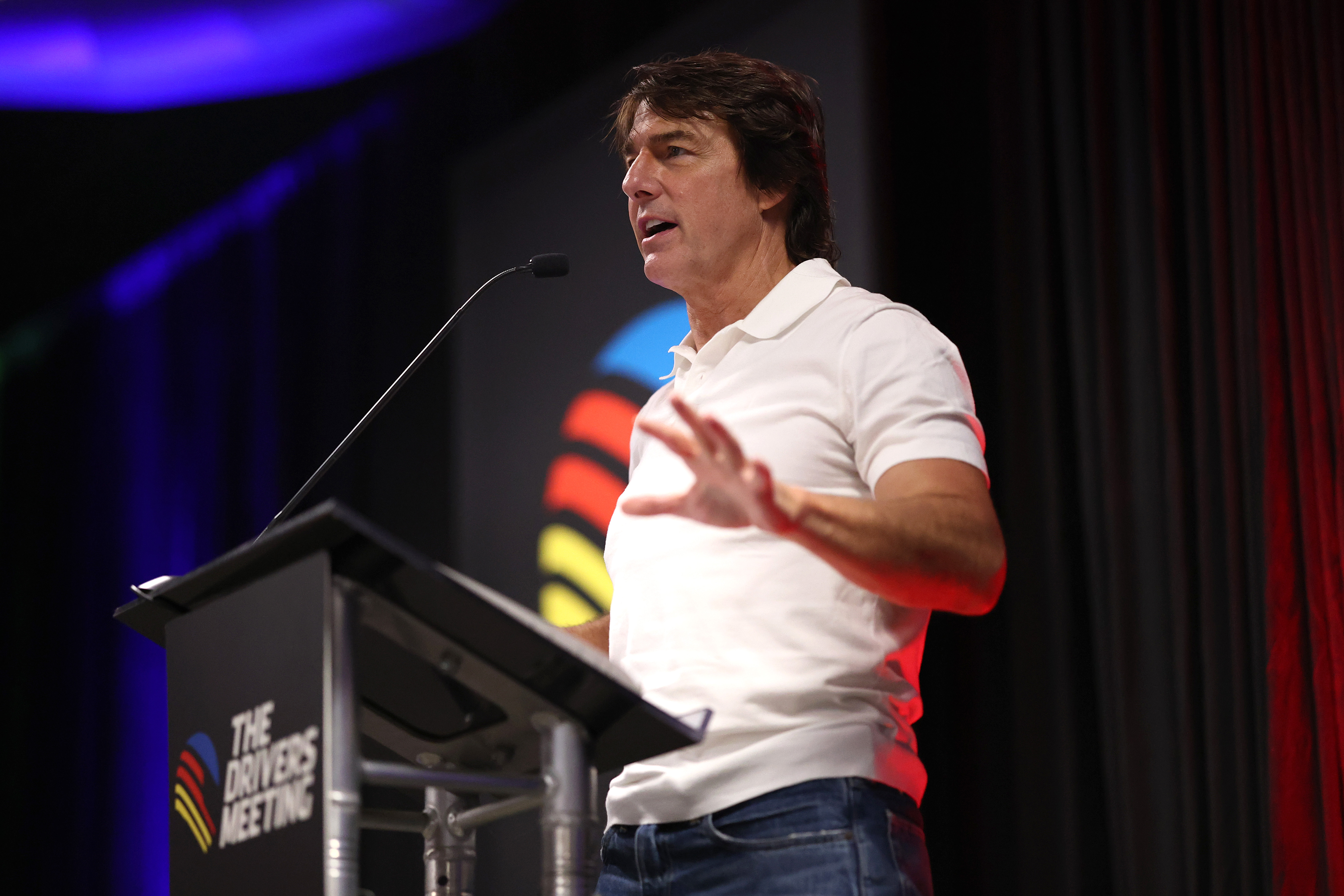 Tom Cruise speaks during a drivers meeting at Daytona International Speedway on August 29, 2026. His conversation with Taylor Swift at the Chiefs game later sparked questions about what the two were discussing. | Source: Getty Images