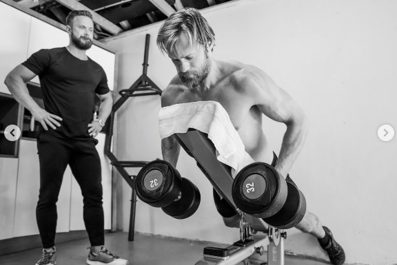 Magnus Lygdback observed as a shirtless Alexander Skarsgård trained with dumbbells as part of the strength-focused preparation that helped the actor add about 20 pounds for the Viking role. | Source: Instagram/aidanmonaghanphotographer
