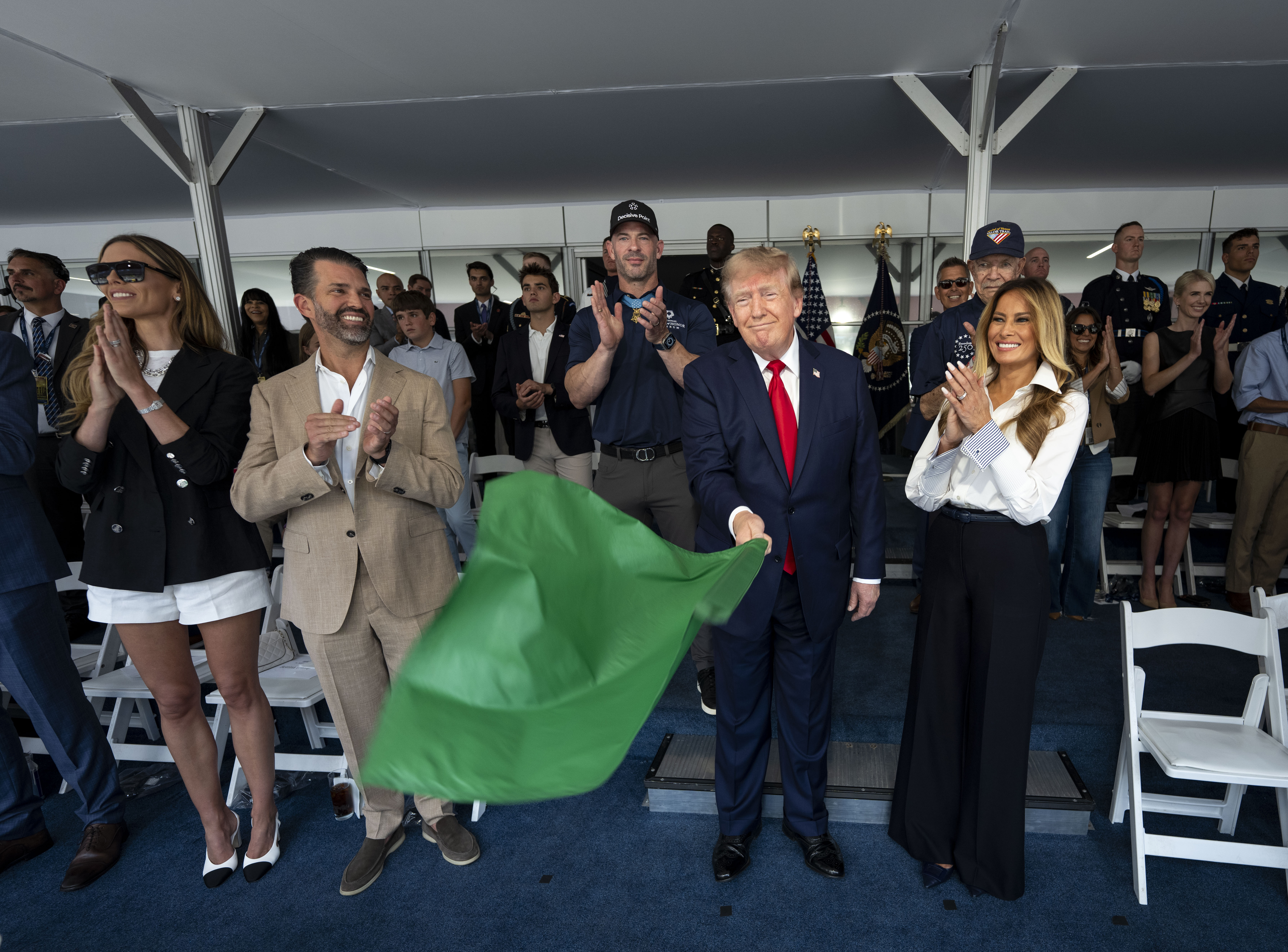 Donald Trump waved the green flag alongside Melania Trump and Donald Trump Jr. during the NTT INDYCAR Series Freedom 250 on August 23, 2026, in Washington, D.C. | Source: Getty Images