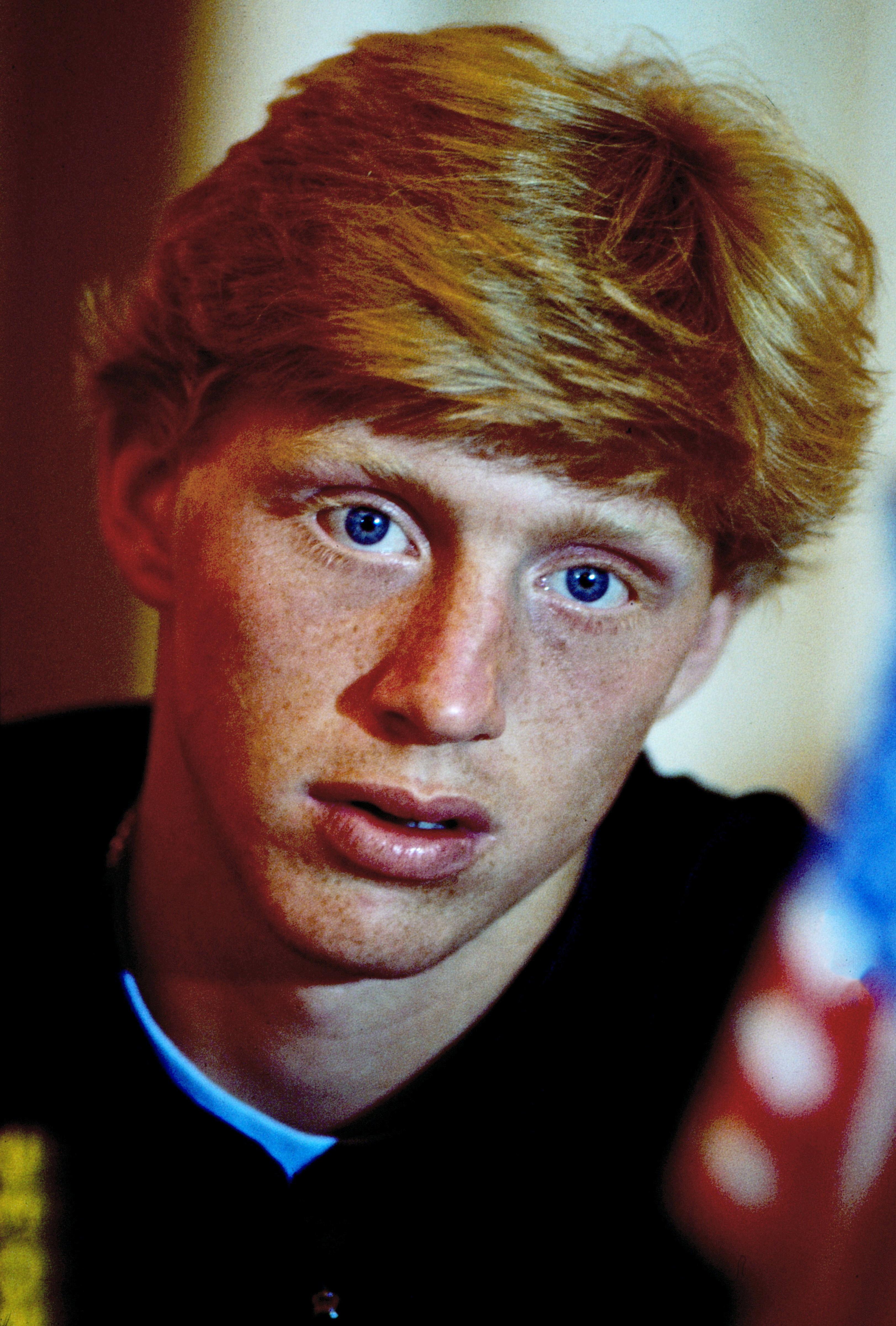 Boris Becker appeared in a close-up portrait taken around 1985, the year the German teenager announced himself as one of tennis's brightest young stars. At just 17, Boris defeated Kevin Curren to capture his first Wimbledon men's singles title, making history as the tournament's youngest men's champion and beginning a Grand Slam career that would eventually produce six major singles titles.