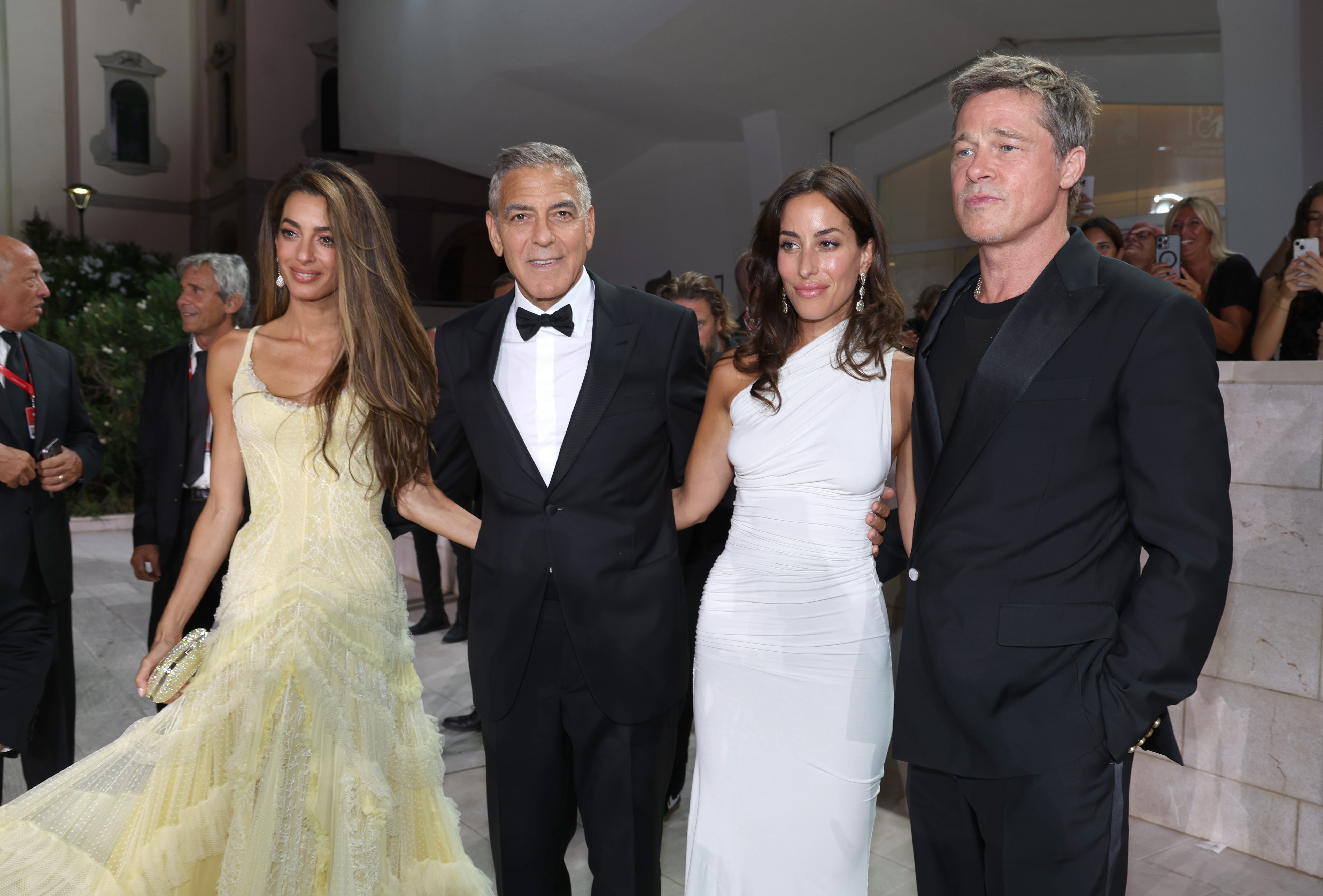 Amal and George Clooney, Ines de Ramon, and Brad Pitt pose together on the red carpet at the 81st Venice International Film Festival on September 1, 2024 | Source: Getty Images