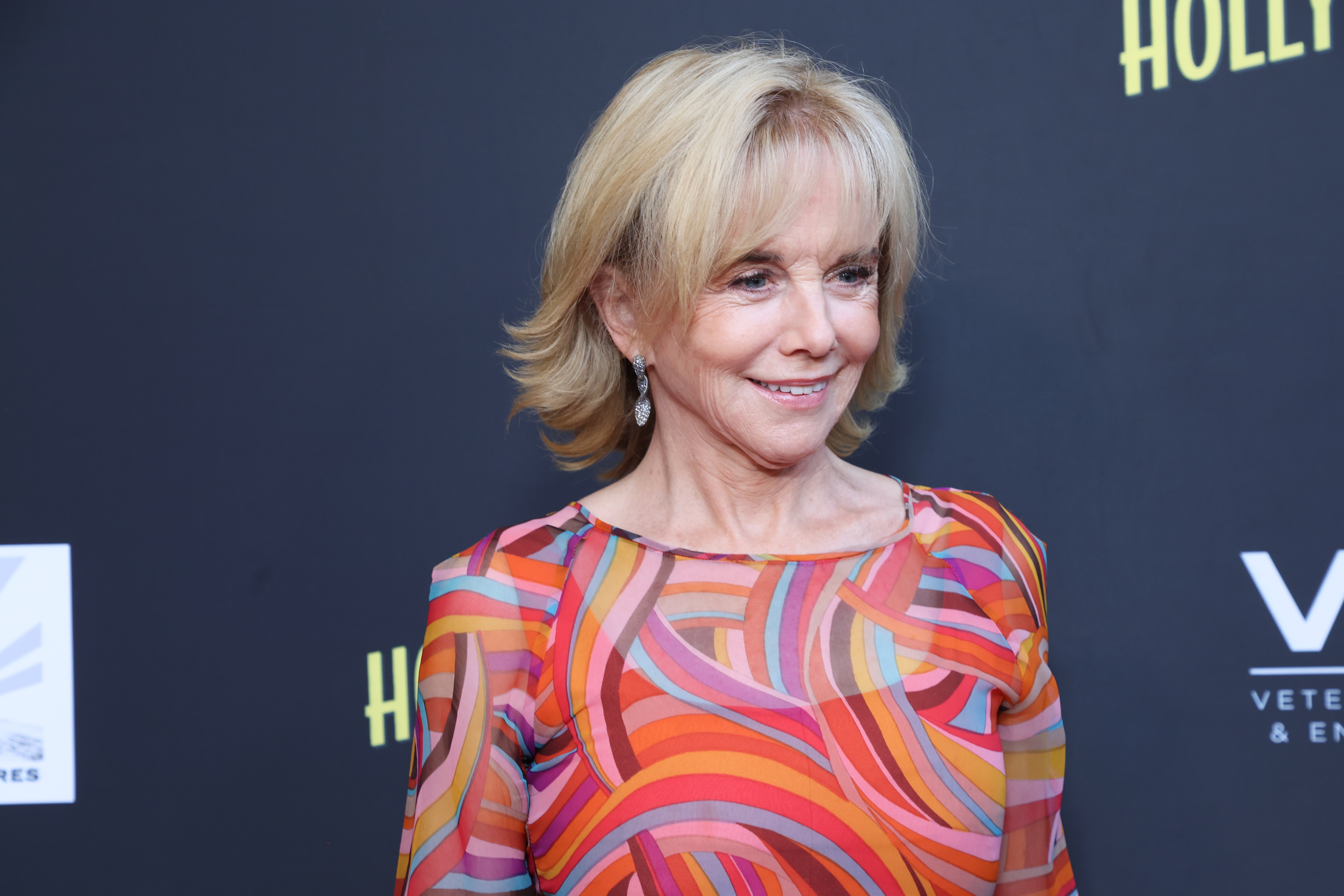 Solo on the red carpet for the premiere of "Hollywood Grit" at The Grove on August 21, 2025, 69-year-old Linda Purl radiated effortless charm and poise. Her swirling, warm-toned boatneck blouse paired with sparkling drop earrings and a feathered blonde bob, beautifully highlighting her bright blue eyes and the graceful elegance of her late 60s. | Source: Getty Images