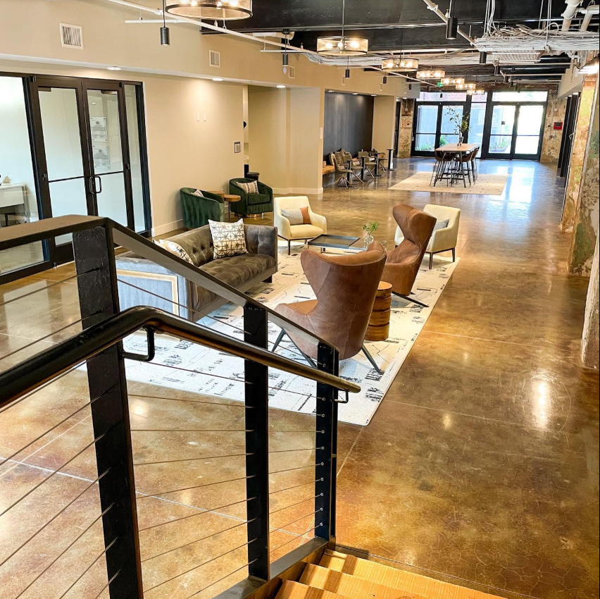 The leasing office blends the mill's industrial history with a polished, welcoming feel, featuring exposed brick, concrete floors and a lounge area filled with midcentury-inspired seating. | Source: Facebook/Judson Mills Loft