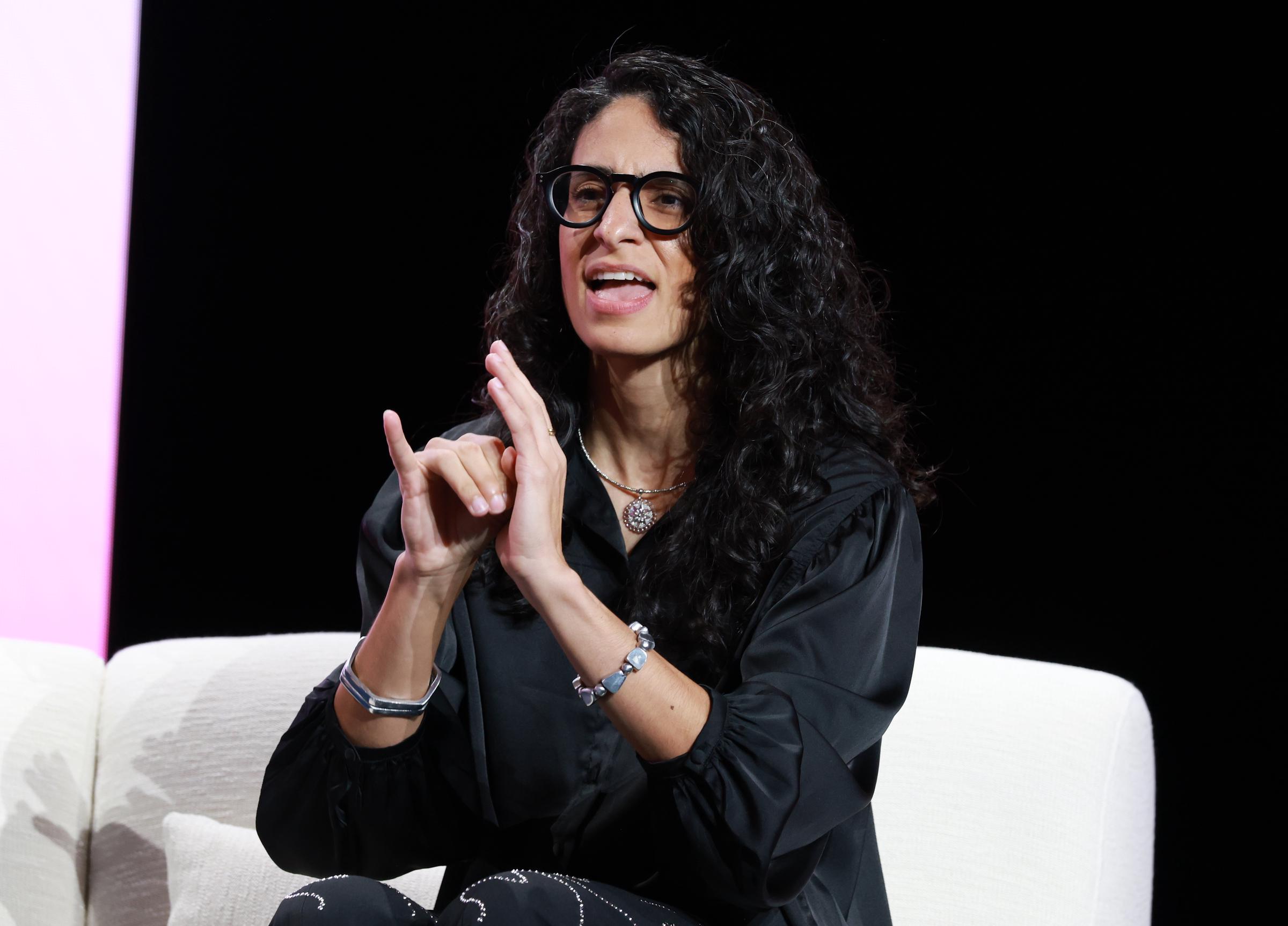Celimar Rivera Cosme signs onstage during the Super Bowl LX pregame and halftime show press conference on February 5, 2026 | Source: Getty Images