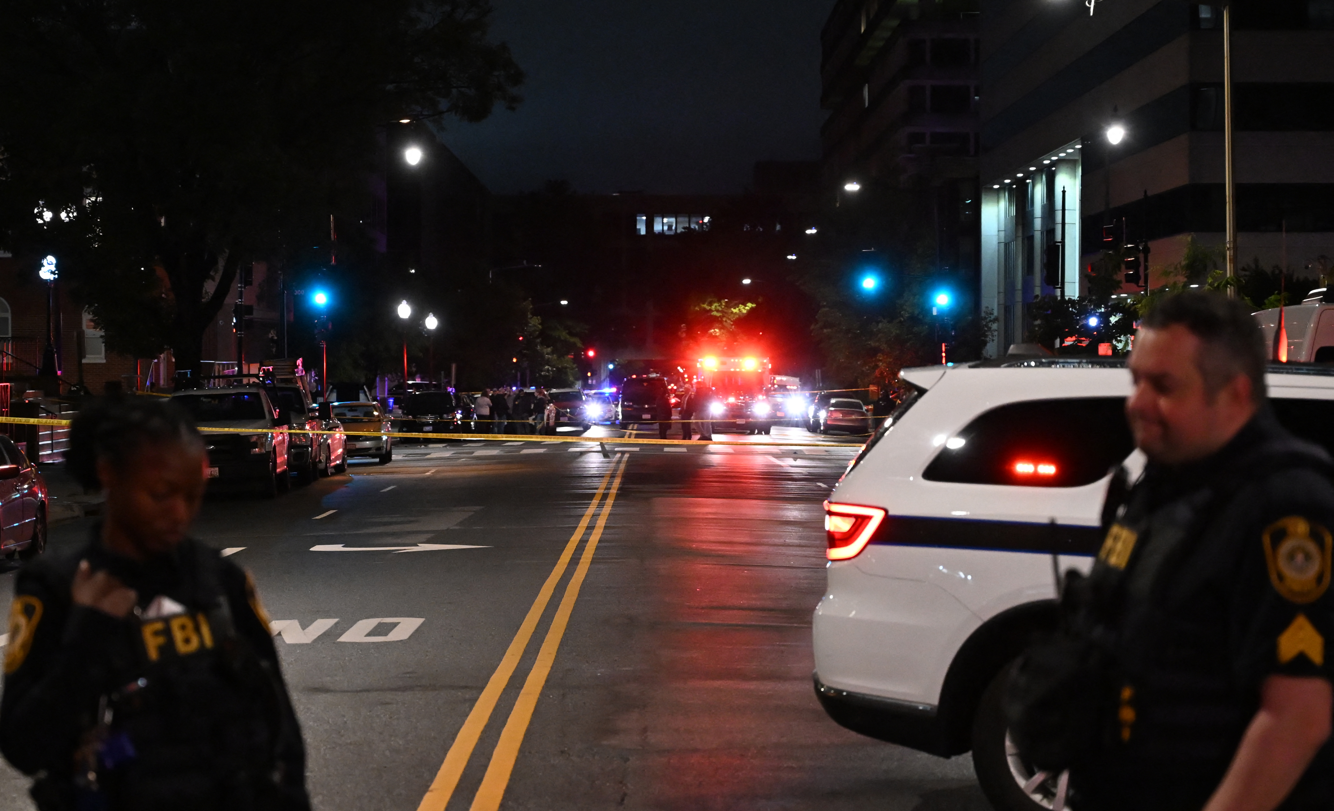 Emergency vehicles are seen in the distance as FBI agents guard the scene outside the Capital Jewish Museum following a shooting that left two people dead, in Washington, D.C., in the early hours of May 22, 2025 | Source: Getty Images