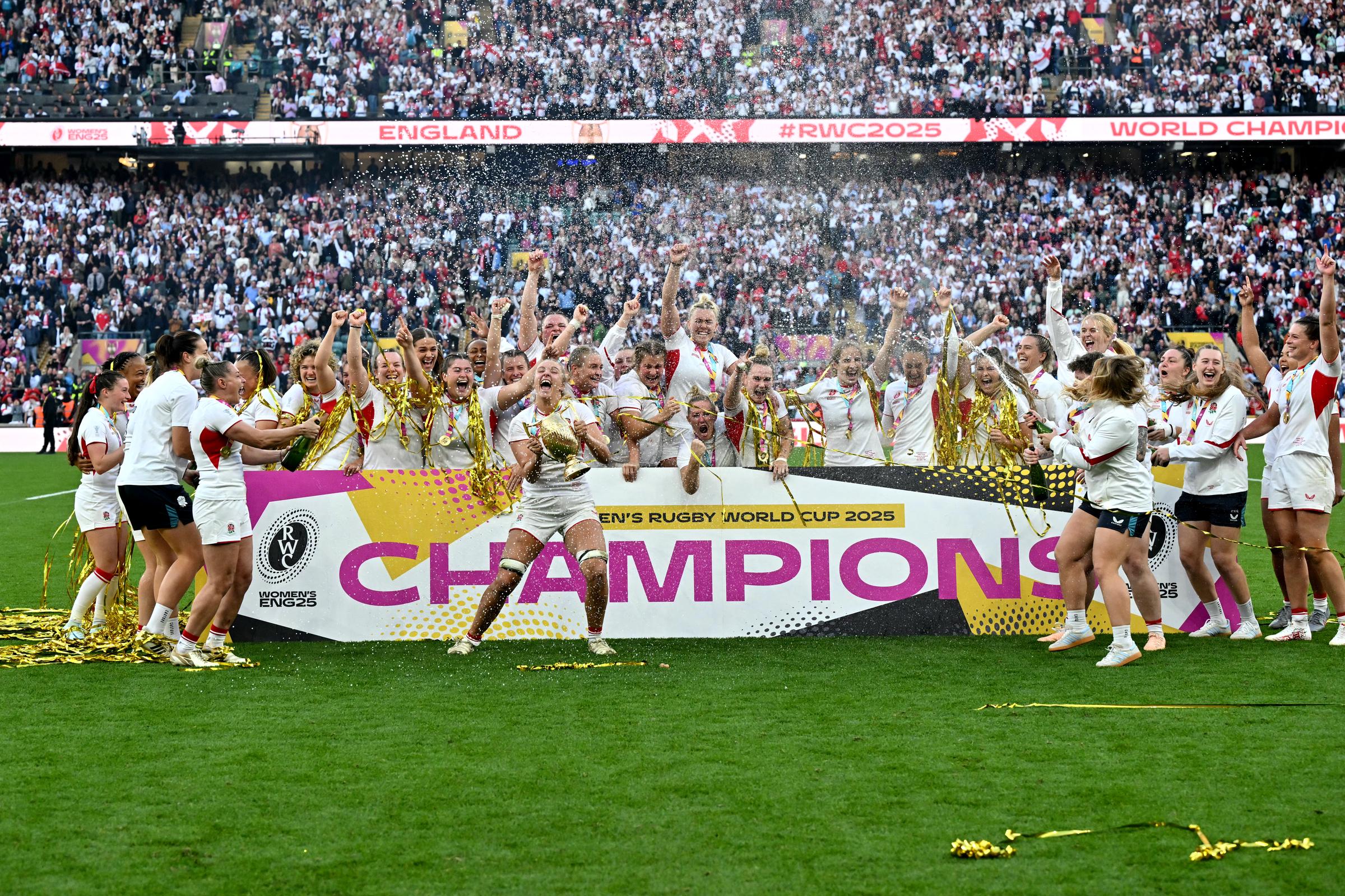 England's flanker Zoe Aldcroft holding the trophy as she and the rest of the Red Roses celebrate their victory at the Women's Rugby World Cup Final in Twickenham, south-west London on September 27, 2025. | Source: Getty Images