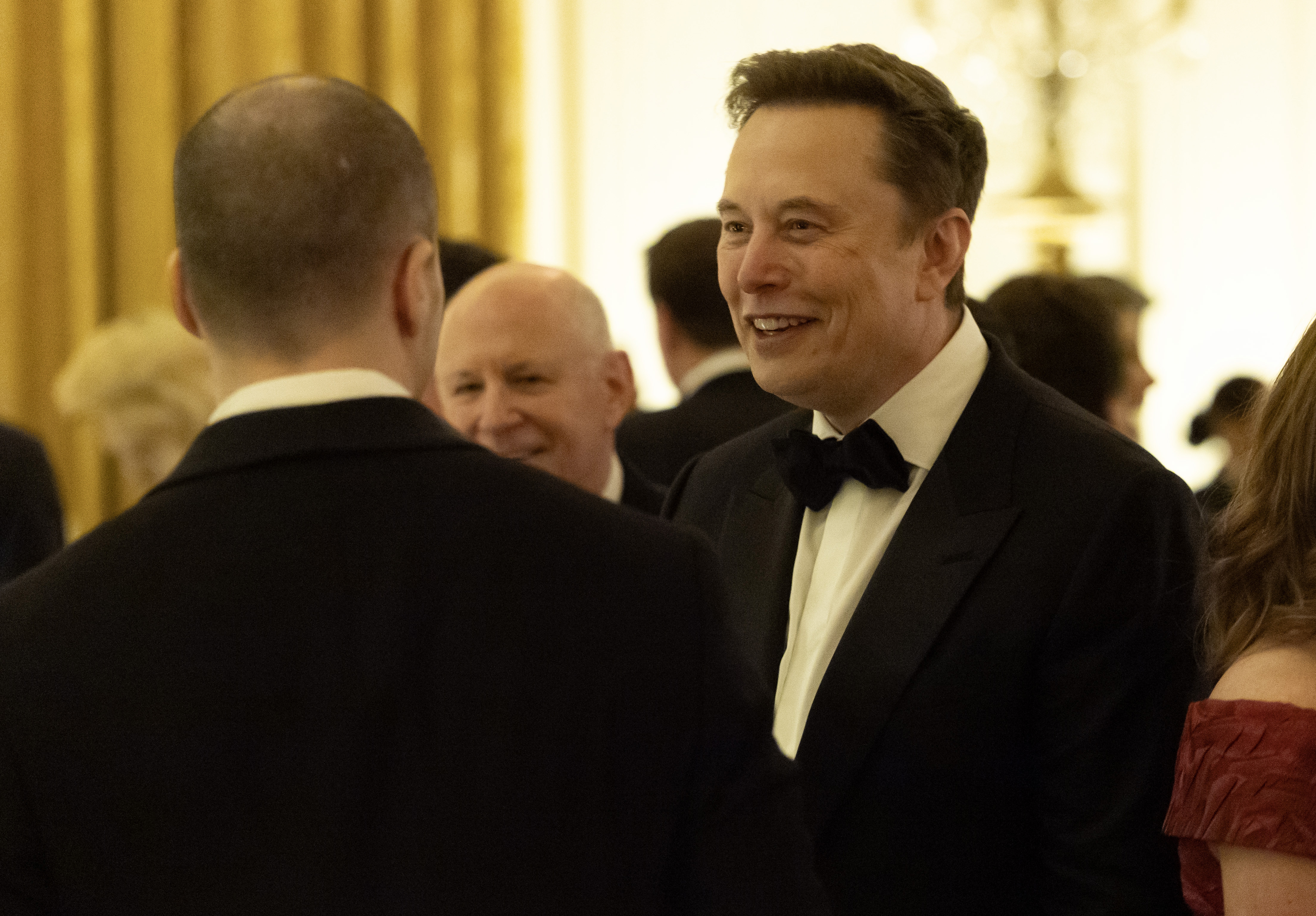 Elon Musk shared a warm laugh while mingling with guests in the East Room of the White House on September 24, 2026, in Washington, DC. Attending the official state dinner hosted by President Donald Trump for Chinese President Xi Jinping, the Tesla chief executive donned a sharp black tuxedo and bow tie as leading tech executives and diplomats gathered to discuss global commerce and the strategic future of artificial intelligence. | Source: Getty Images