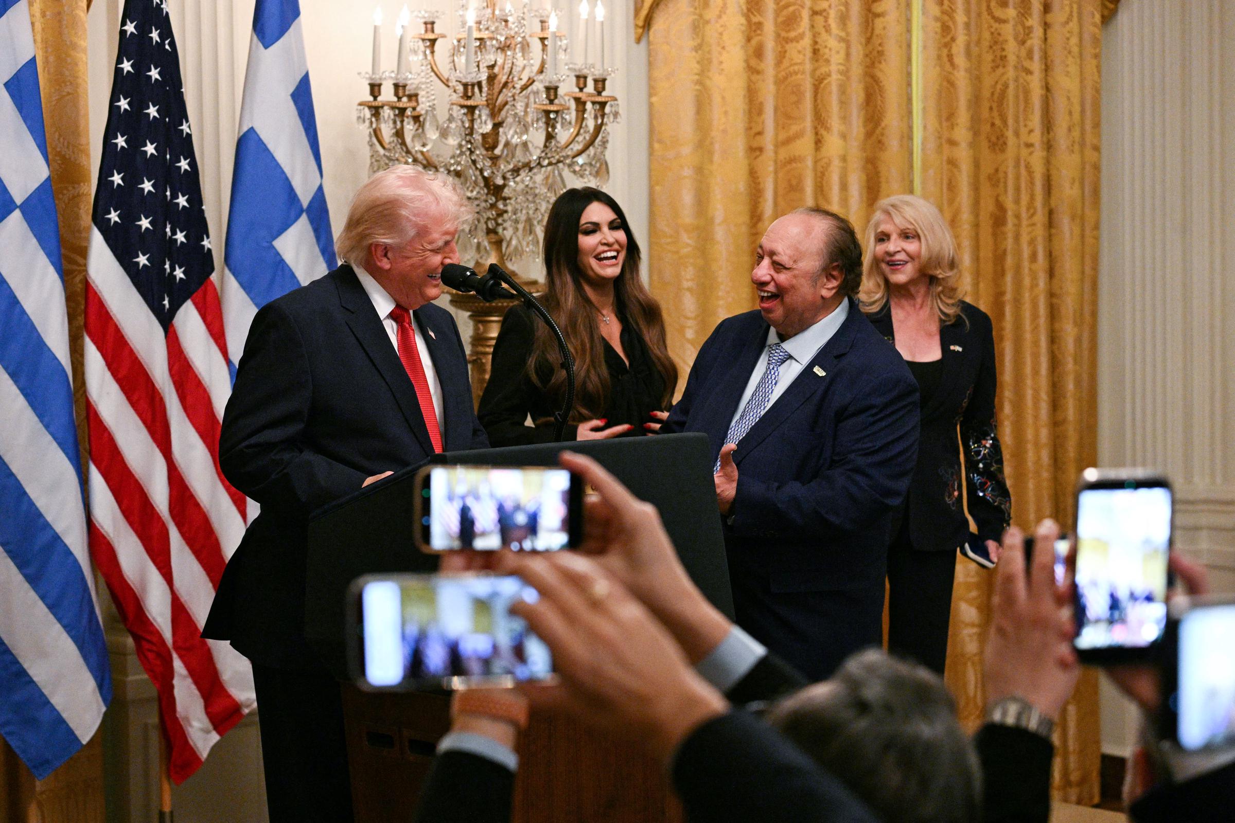Trump shared a laugh with John Catsimatidis during the event as Kimberly Guilfoyle and Margo Catsimatidis looked on. The ceremony brought together political, business and Greek American community leaders. | Source: Getty Images