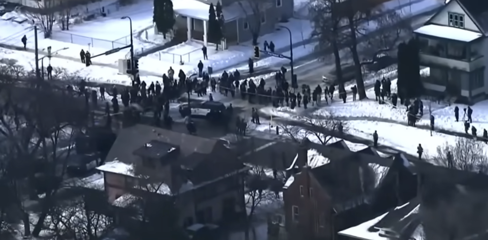 Crowds gathered where Renee Nicole Good's car crashed after being shot by an ICE agent on January 7, 2026 | Source: YouTube/NBC News