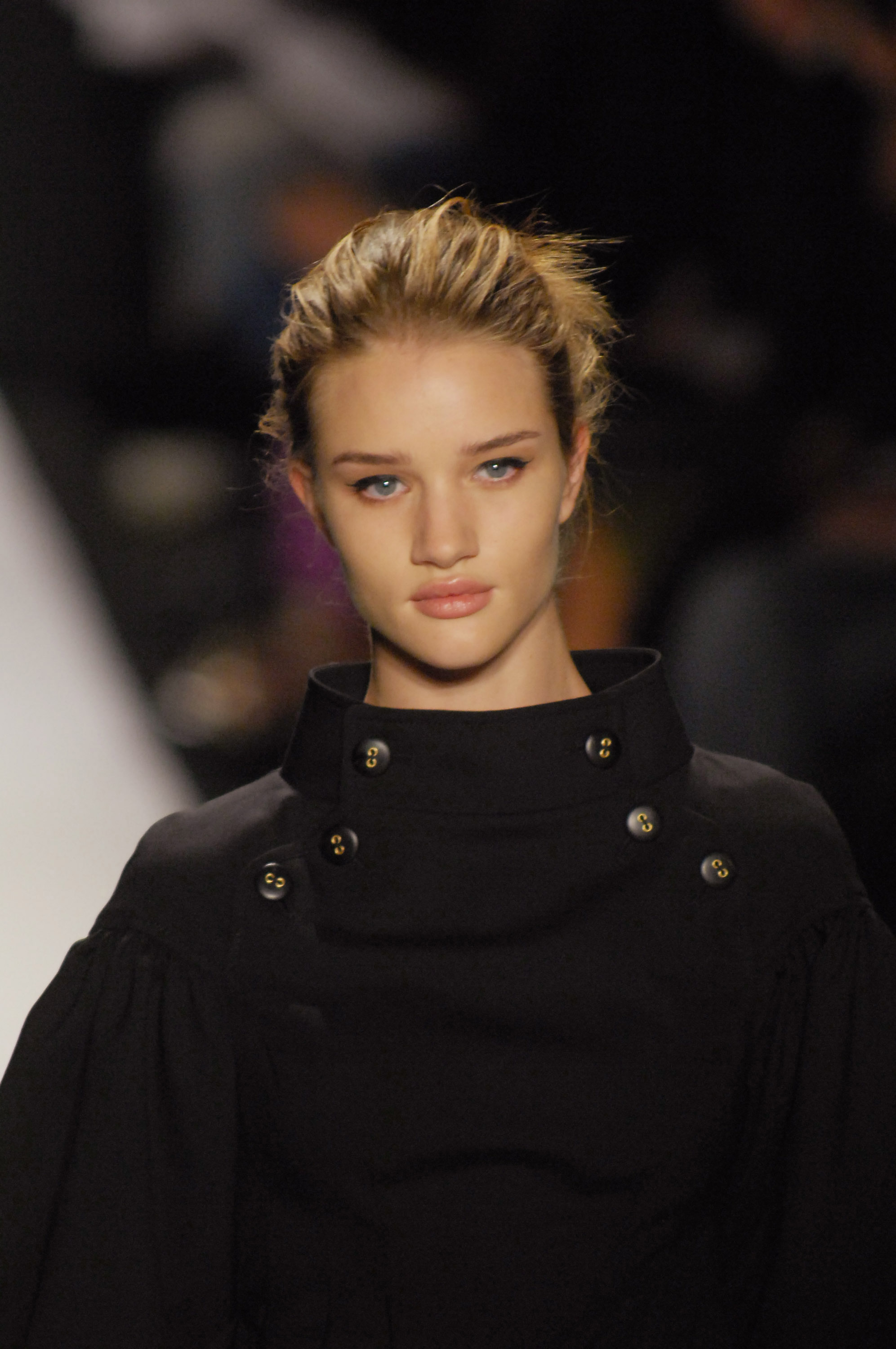 Rosie Huntington-Whiteley delivers runway drama at its finest in a structured black ensemble, her sleek updo and piercing gaze commanding total attention. | Source: Getty Images