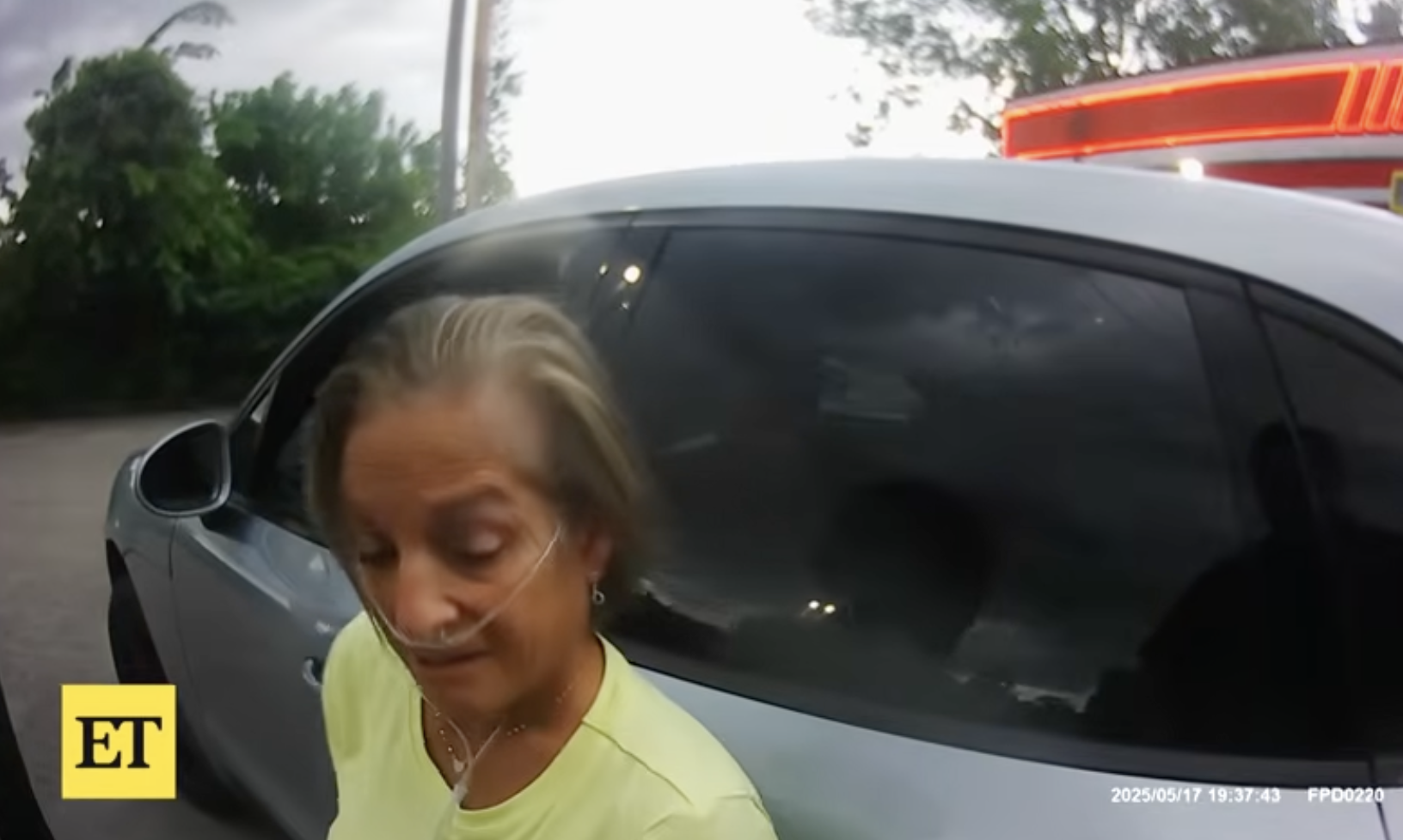 Mary Lou Retton leans against her car while speaking to a law enforcement officer on May 17, 2025 in West Virginia | Source: YouTube/Entertainment Tonight