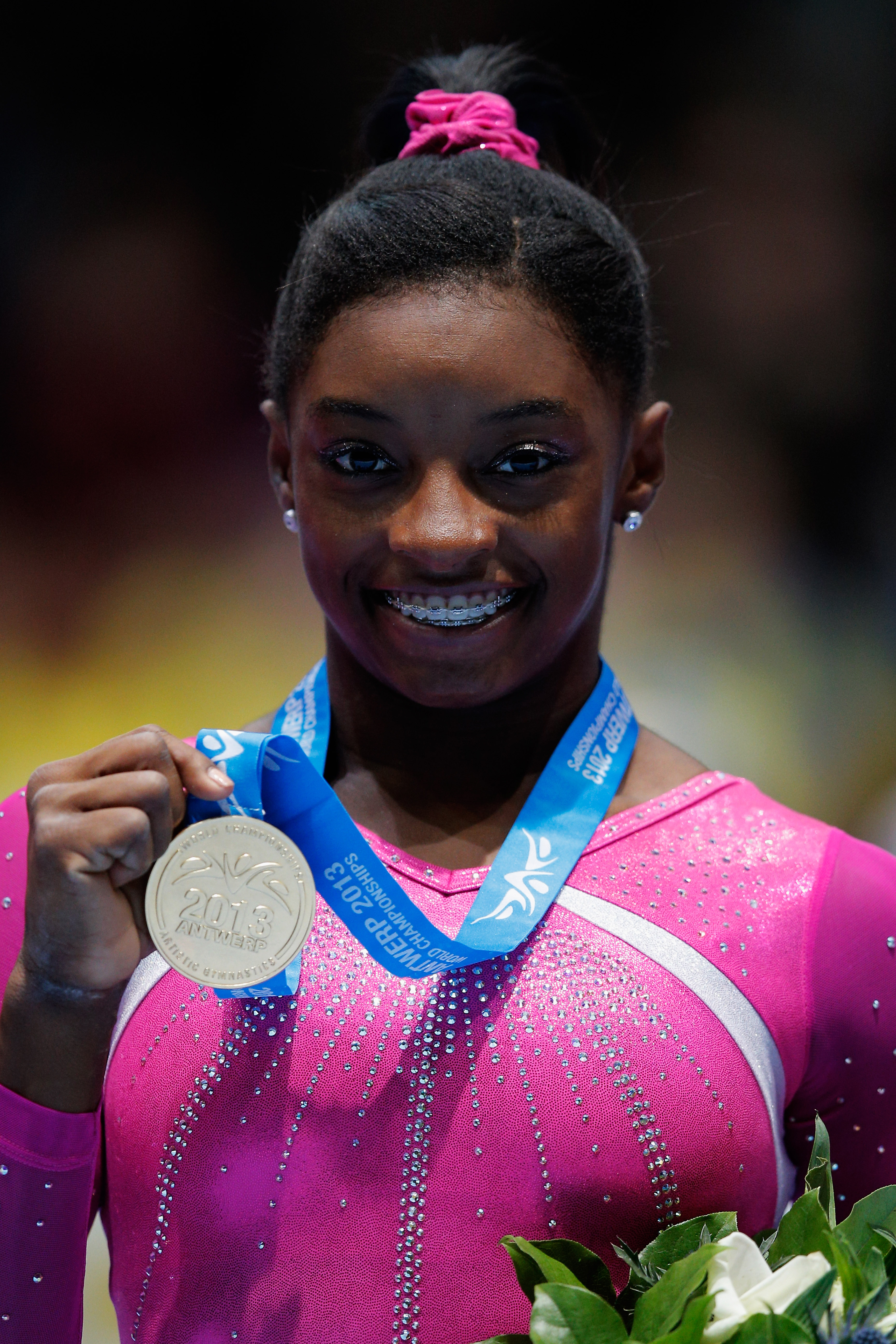 Simone Biles poses after winning the Women's All-Round Final on Day Five of the Artistic Gymnastics World Championships Belgium on October 4, 2013 | Source: Getty Images